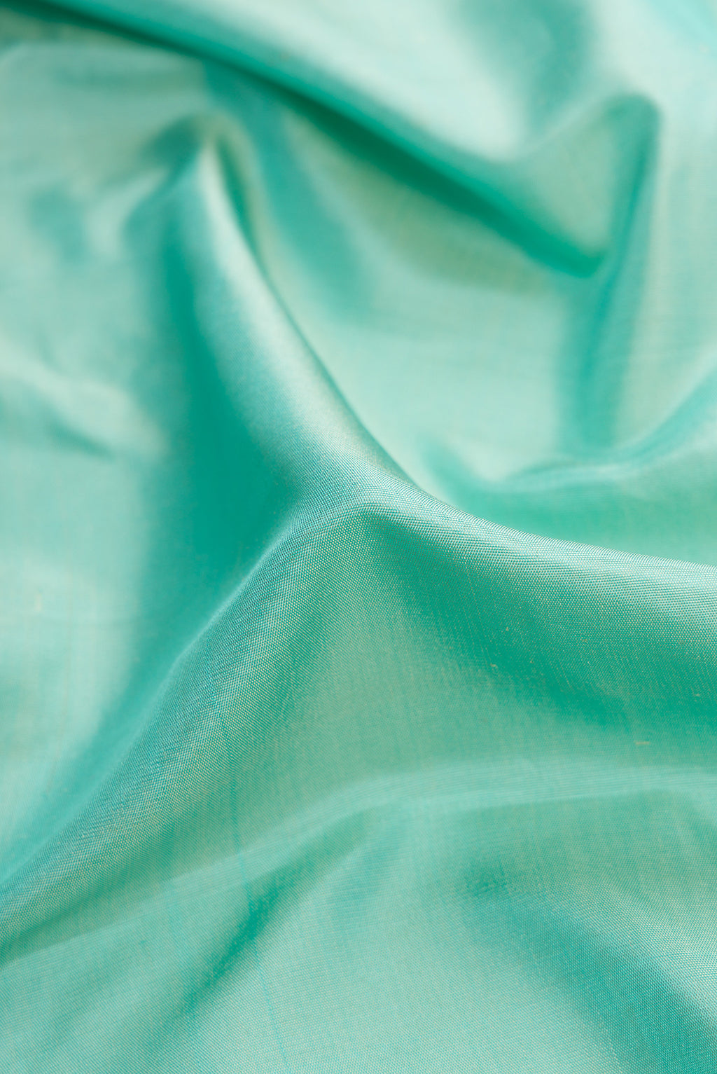 Close up of Sky Blue Dual Tone Gadwal Silk Saree with Plain Body and Zari Border.  displaying folds