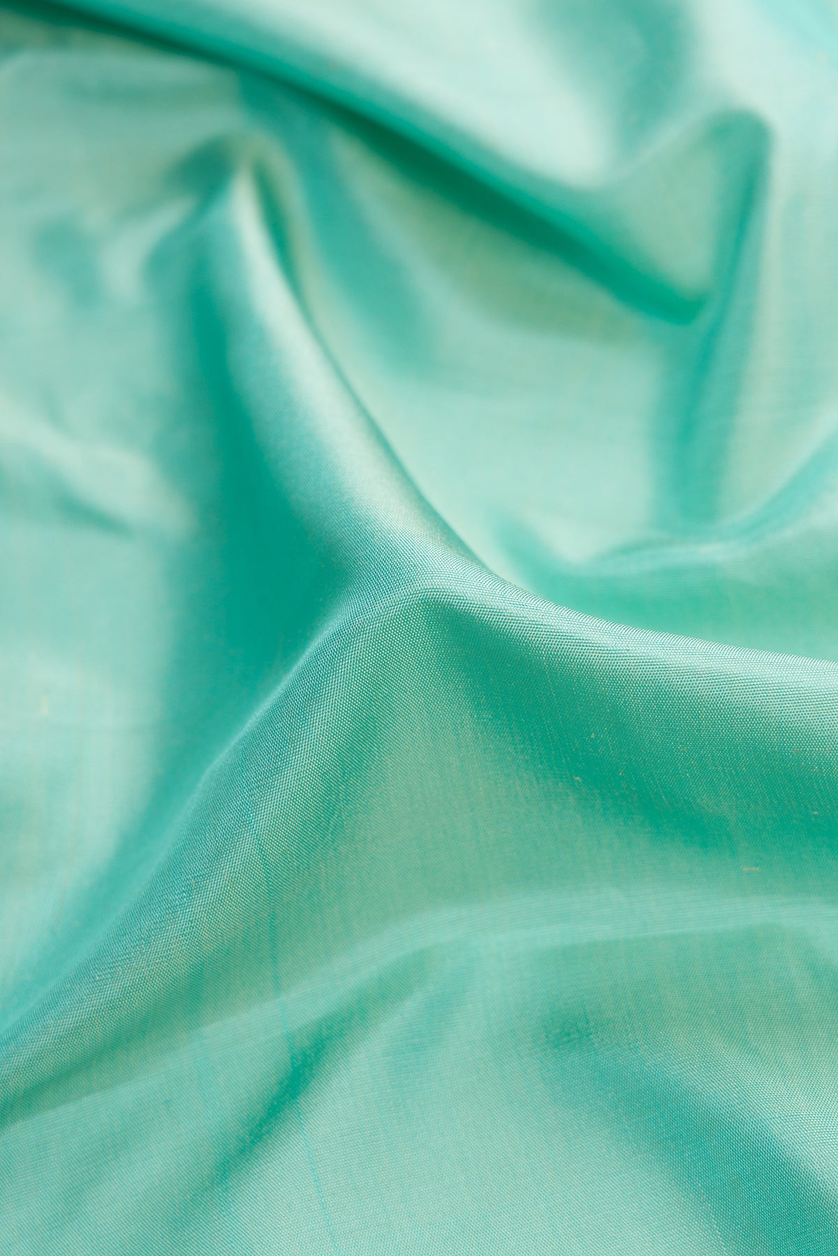 Close up of Sky Blue Dual Tone Gadwal Silk Saree with Plain Body and Zari Border.  displaying folds
