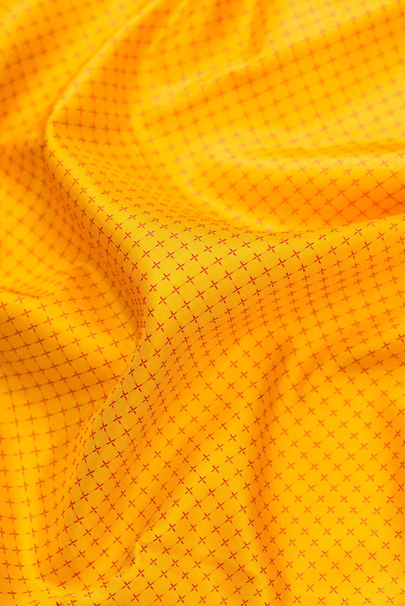 Close up of Pure Silk Pure Zari Yellow Dual Tone Kanjivaram Saree with Thread Butta on the body and Zari Border.  displaying folds