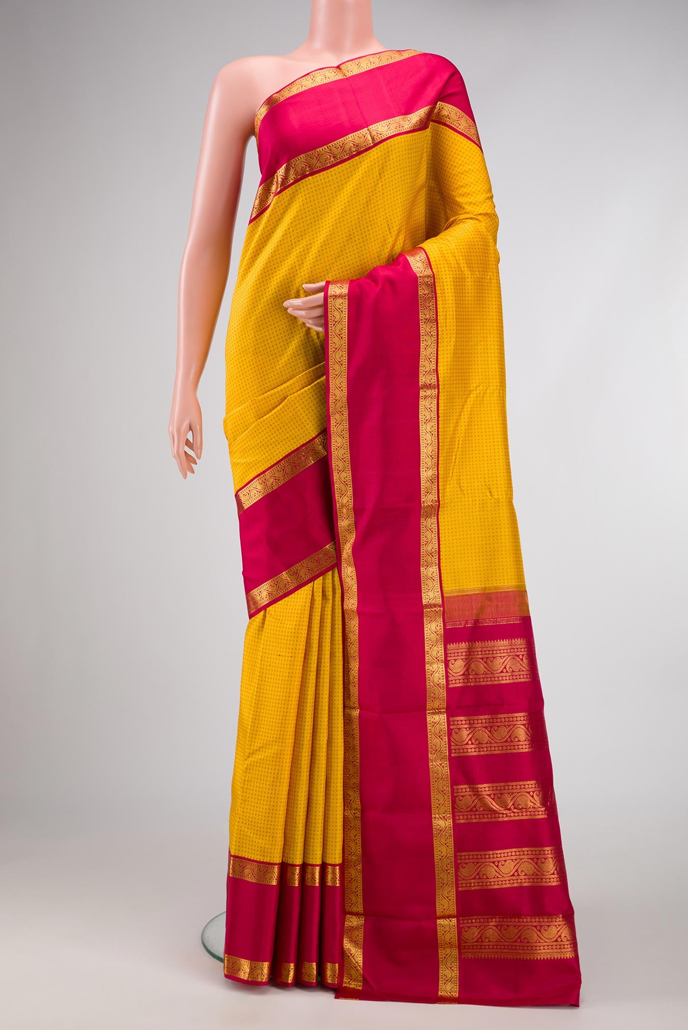Pure Silk Pure Zari Yellow Dual Tone Kanjivaram Saree with Thread Butta on the body and Zari Border.  displayed on a mannequin
