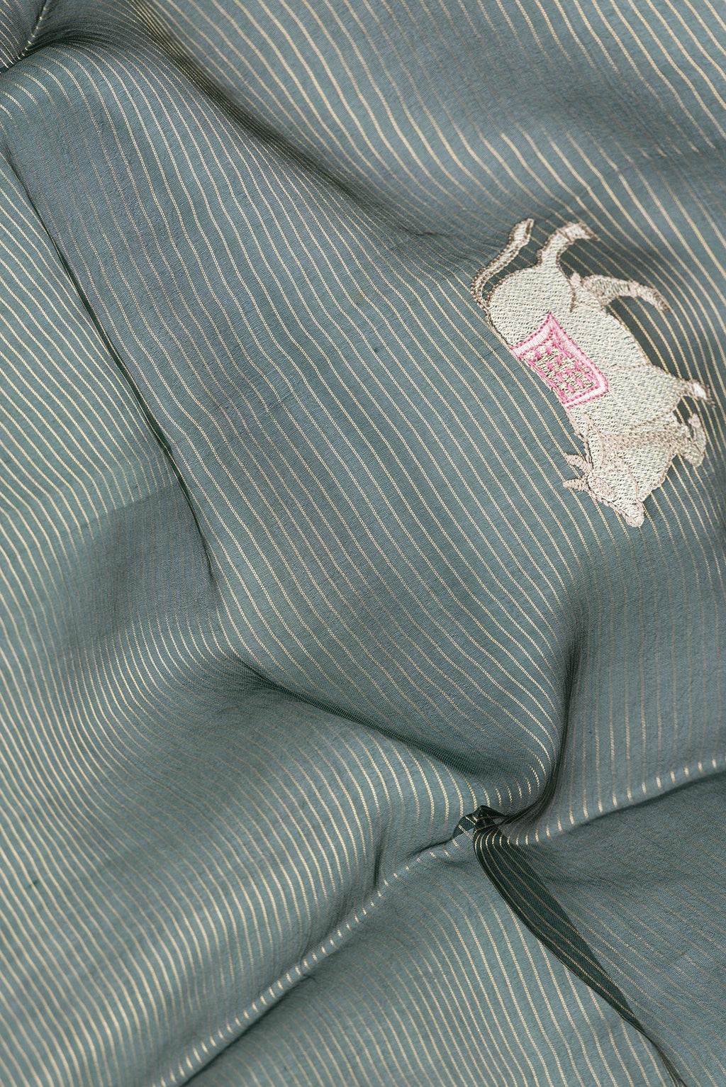 Close up of Bottle Green Dual Tone Organza Silk Saree with Stripes on the body and Fancy Border.  displaying folds