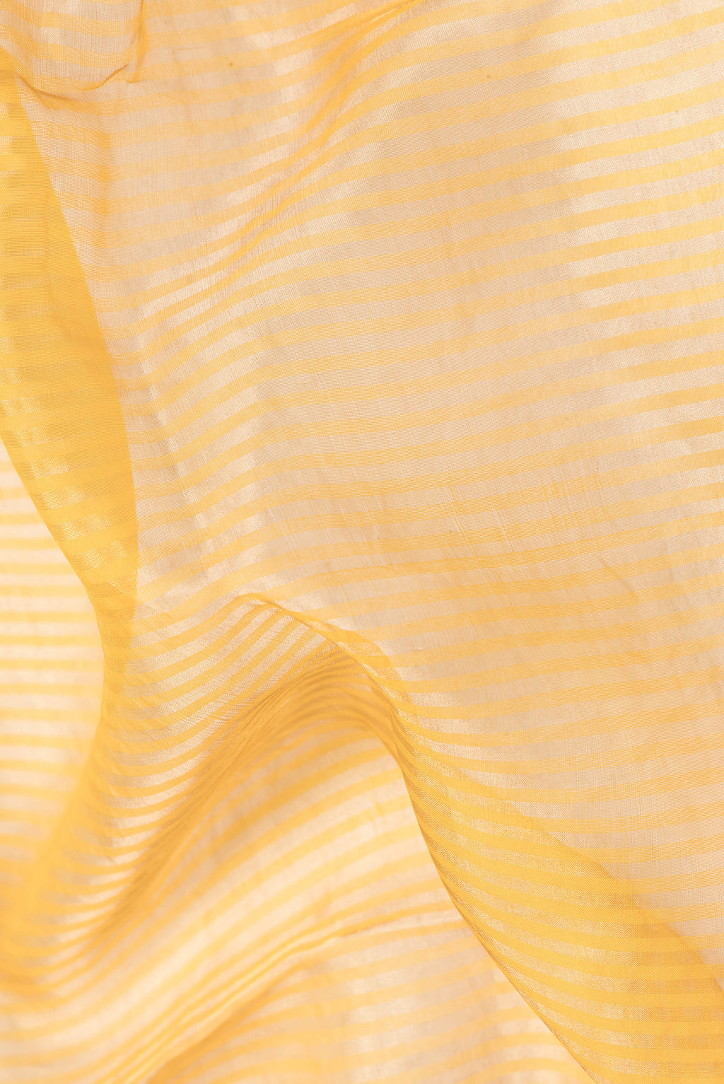 Close up of Orange Dual Tone Organza Silk Saree with Embroidery on the body and Fancy Border.  displaying folds