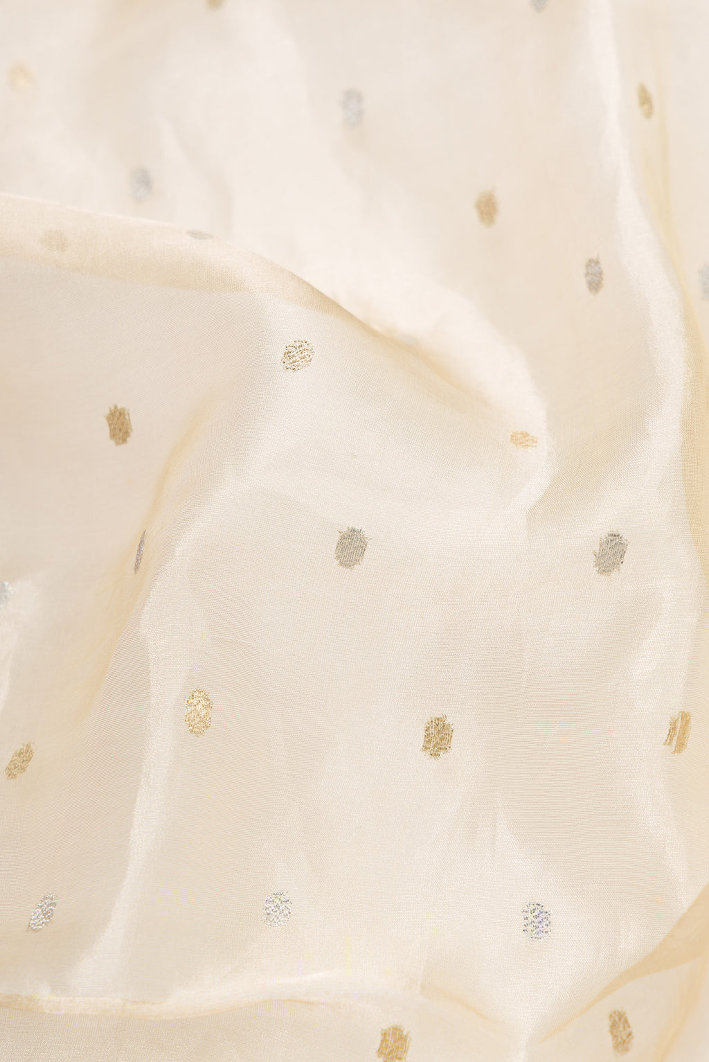 Close up of Sandal Dual Tone Organza Silk Saree with Zari Butta on the body and Fancy Border.  displaying folds