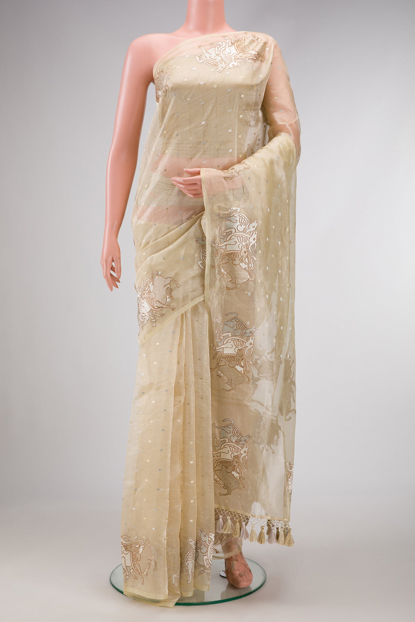 Sandal Dual Tone Organza Silk Saree with Zari Butta on the body and Fancy Border.  displayed on a mannequin