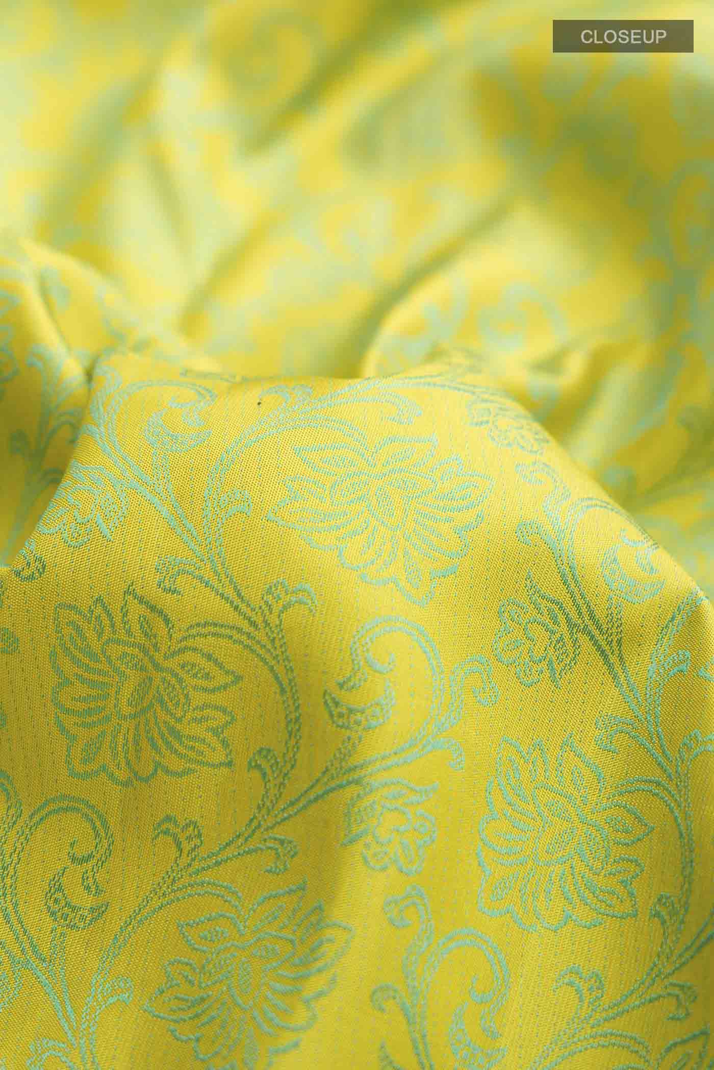 Close up of Green Kanchipuram Silk Saree with Jacquard design on the body and Zari Border displaying folds