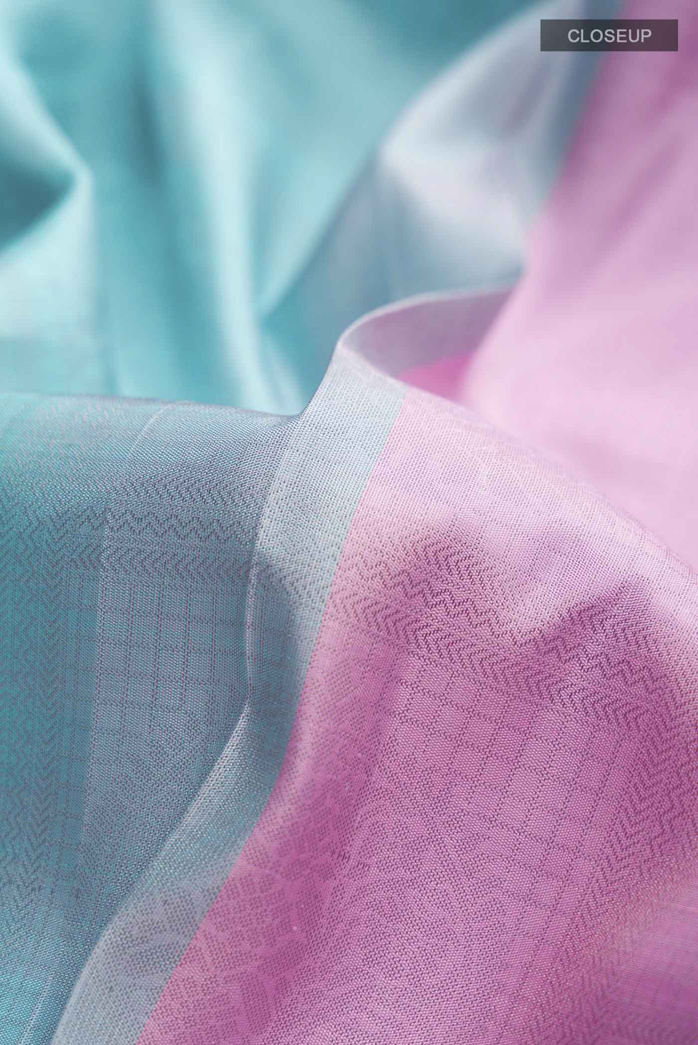 Close up of Pink Kanchipuram Silk Saree with Half And Half on the body and Without Border displaying folds