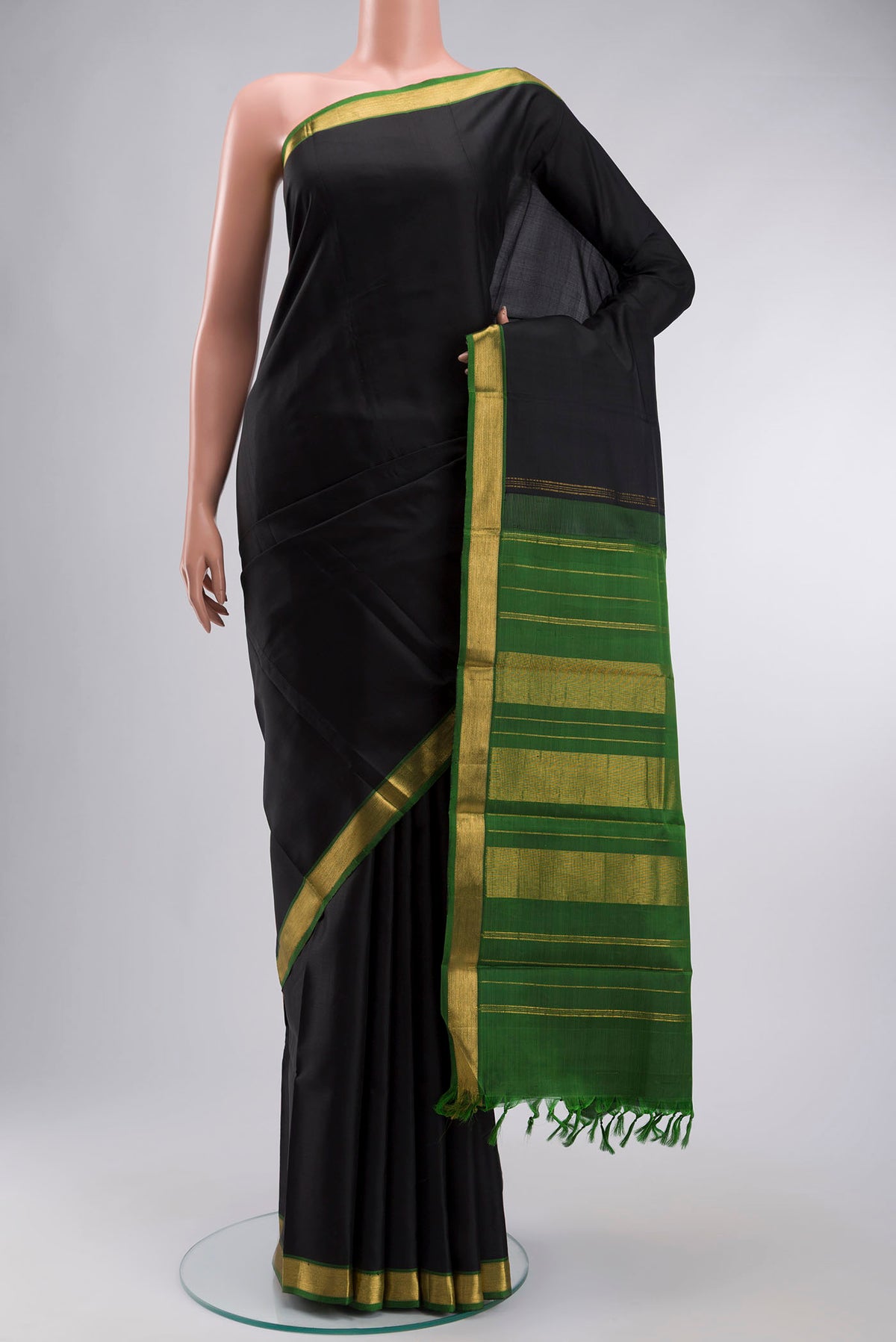 Black Kanchipuram Silk Saree with Plain Body and Zari Border displayed on a mannequin