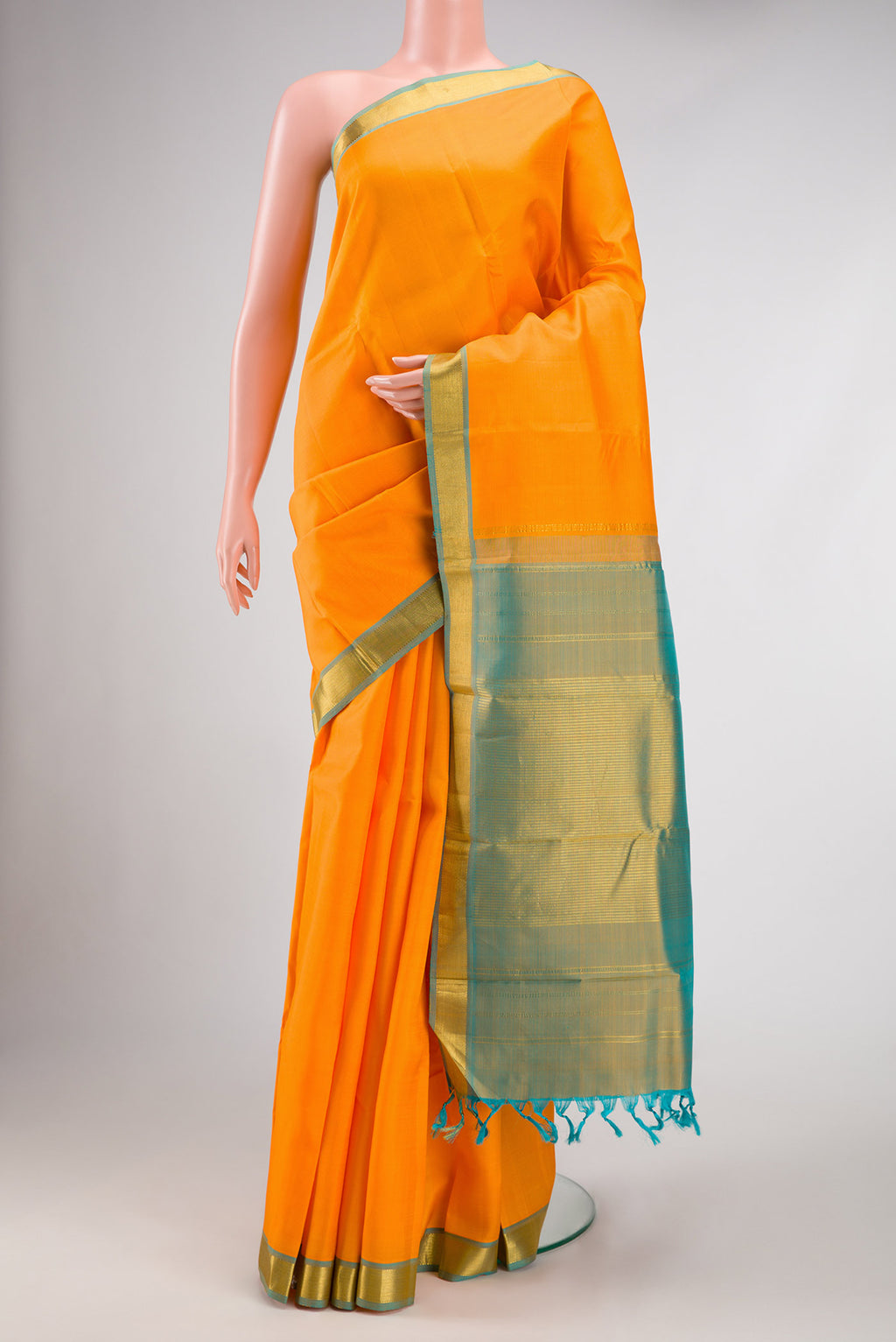 Orange Dual Tone Kanjivaram Silk Saree with Plain Body and Zari Border.  displayed on a mannequin