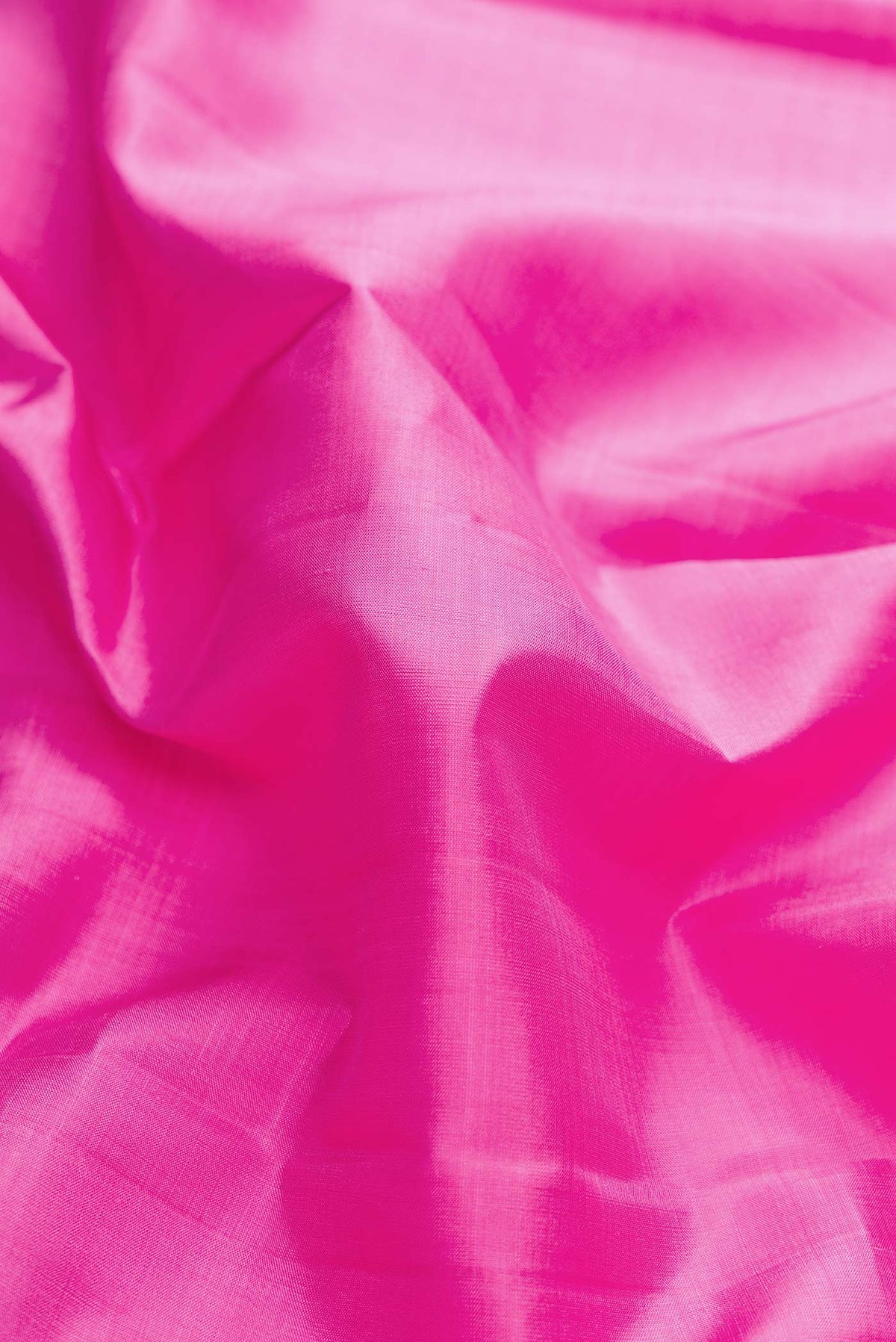 Close up of Pink Dual Tone Kanchipuram Silk Saree with Plain Body and Zari Border displaying folds