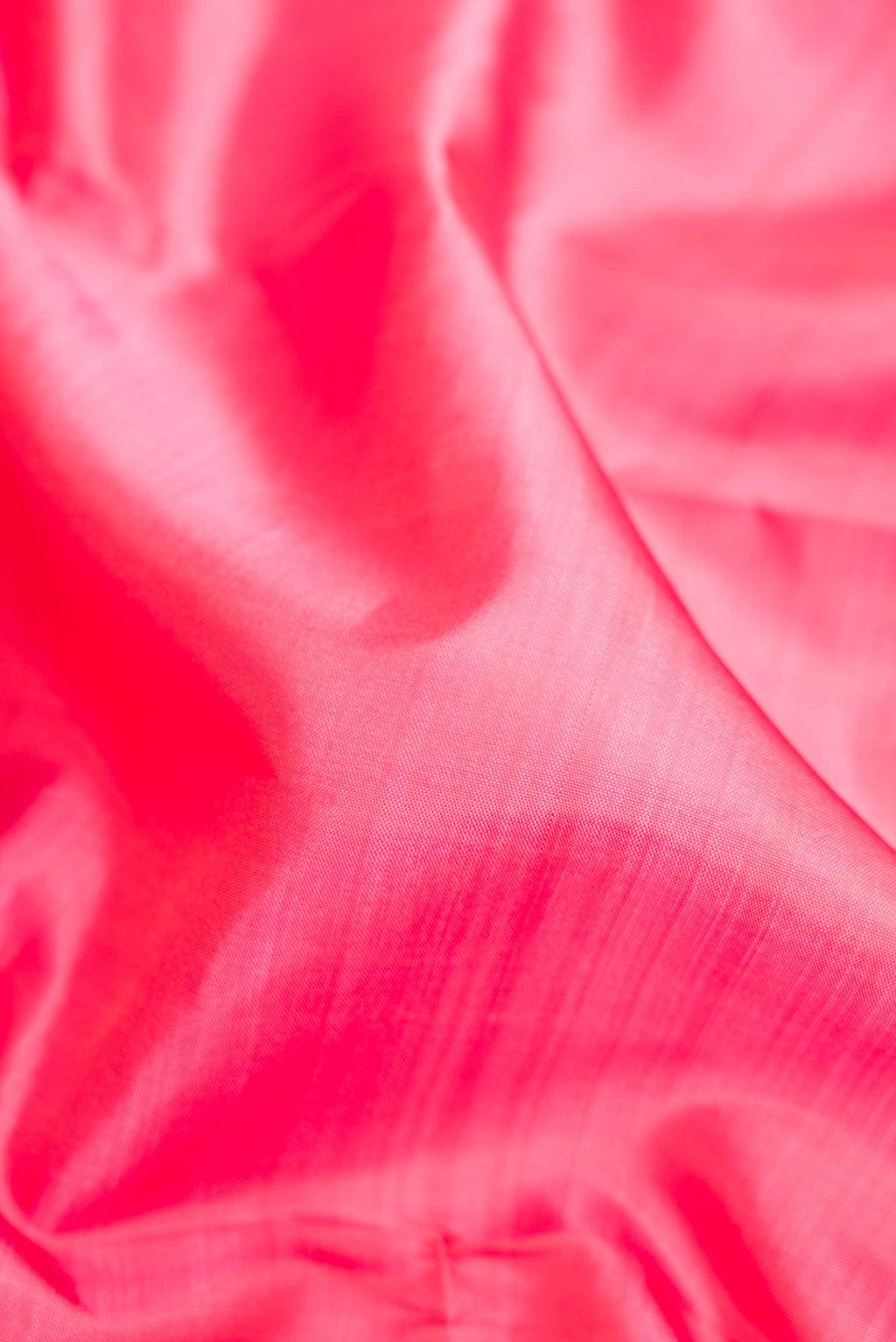 Close up of Pink Dual Tone Kanjivaram Silk Saree with Plain Body and Zari Border.  displaying folds