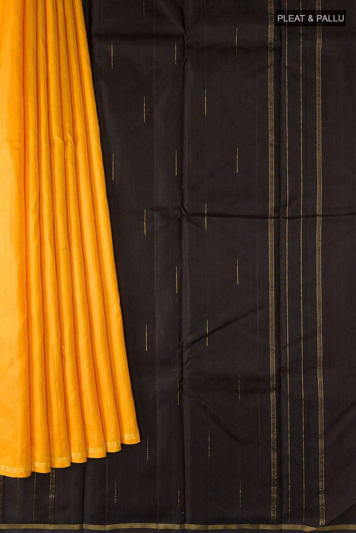 Pleats and pallu of Yellow Kanchipuram Silk Saree with Zari Butta on the body and Zari Border