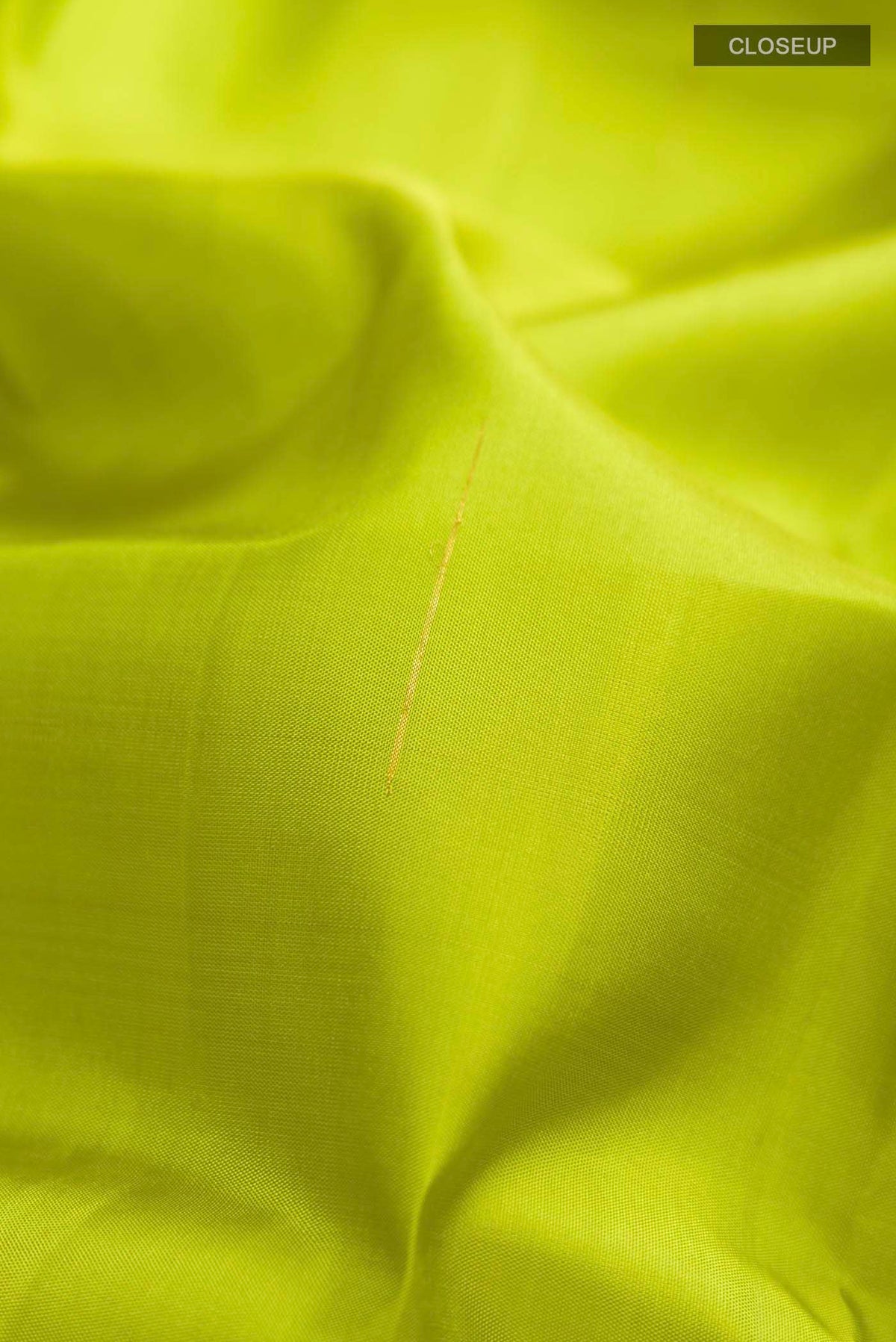 Close up of Green Kanchipuram Silk Saree with Zari Butta on the body and Zari Border displaying folds