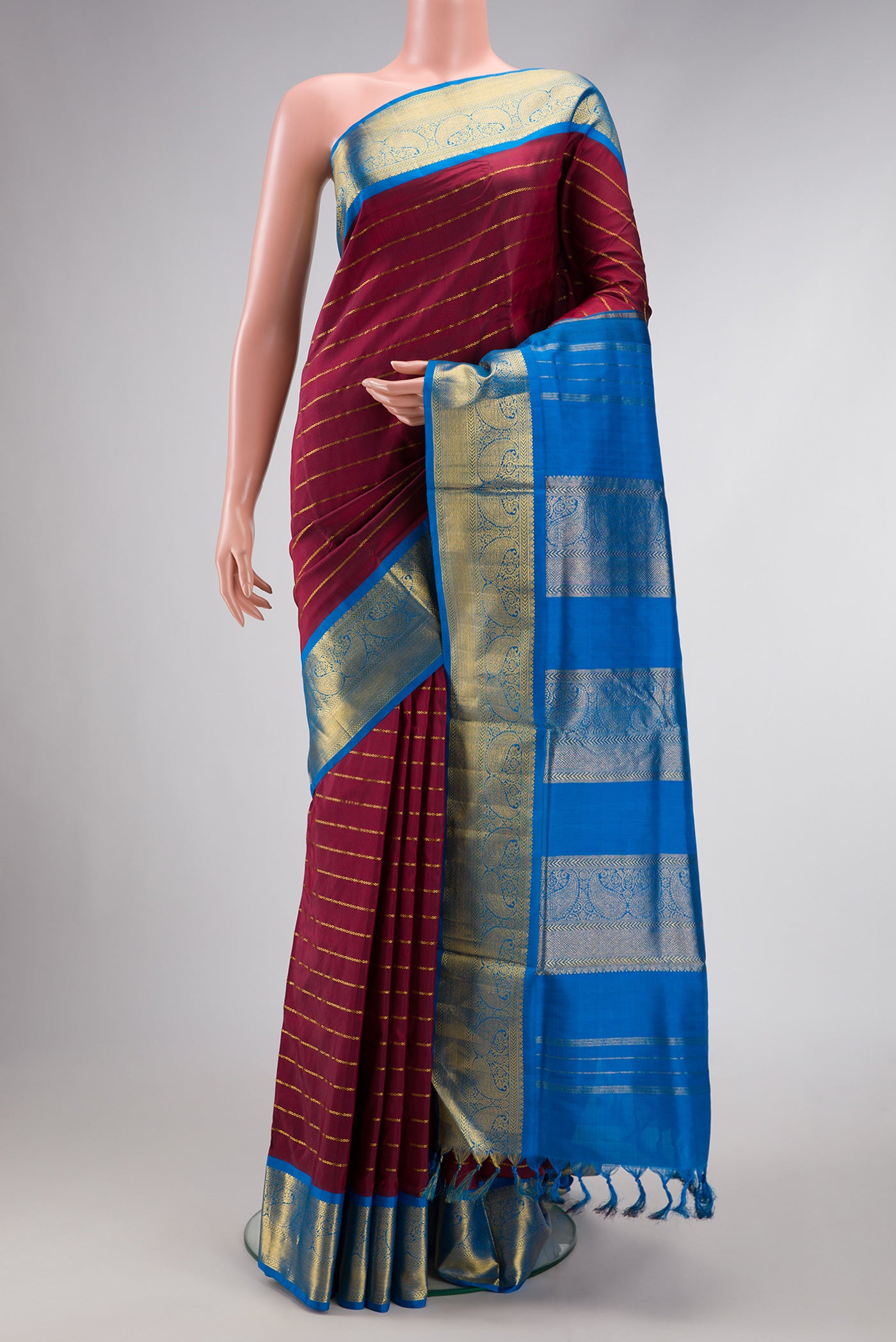 Pure Silk Pure Zari Maroon Dual Tone Kanchipuram Nine Yards Saree with Stripes on the body and Zari Border.  displayed on a mannequin