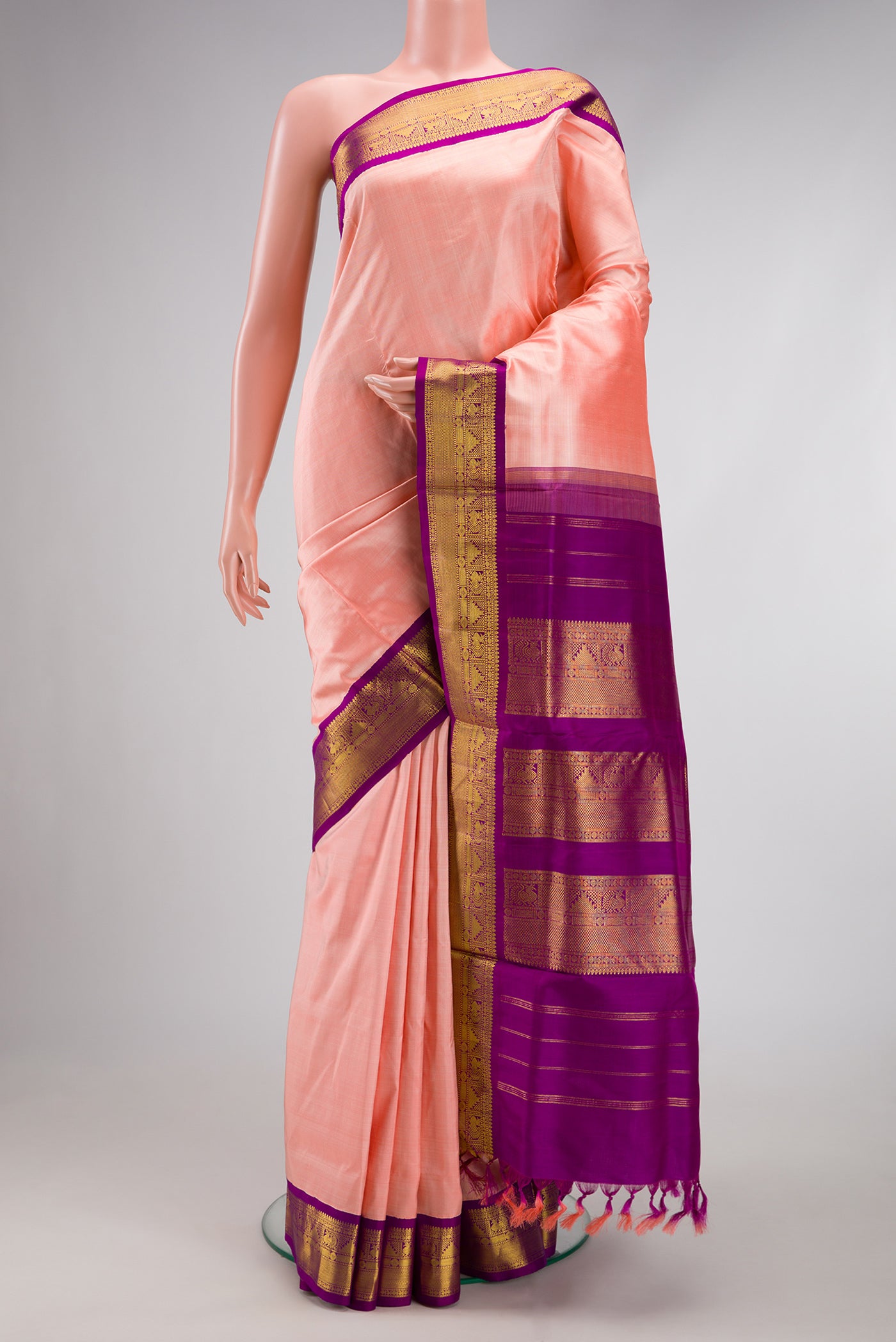 Pure Silk Pure Zari Golden Peach Kanchipuram Nine Yards Saree with Plain Body and Zari Border.  displayed on a mannequin