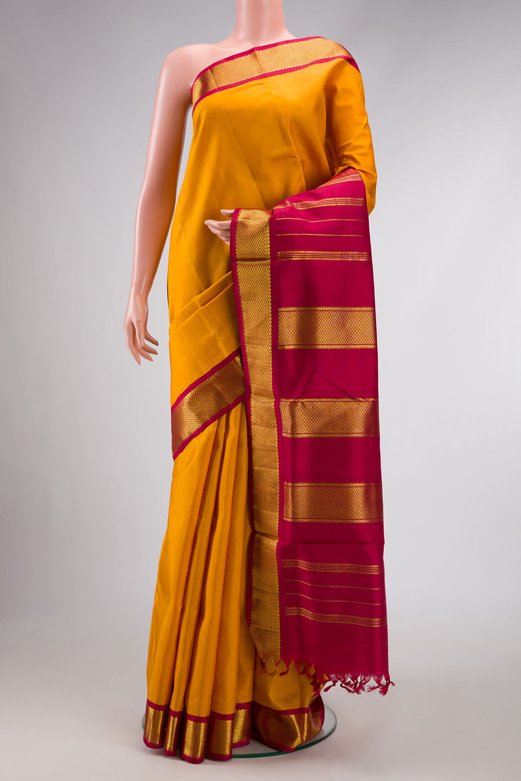 Pure Silk Pure Zari Mustard Dual Tone Kanchipuram Nine Yards Saree with Stripes on the body and Zari Border.  displayed on a mannequin