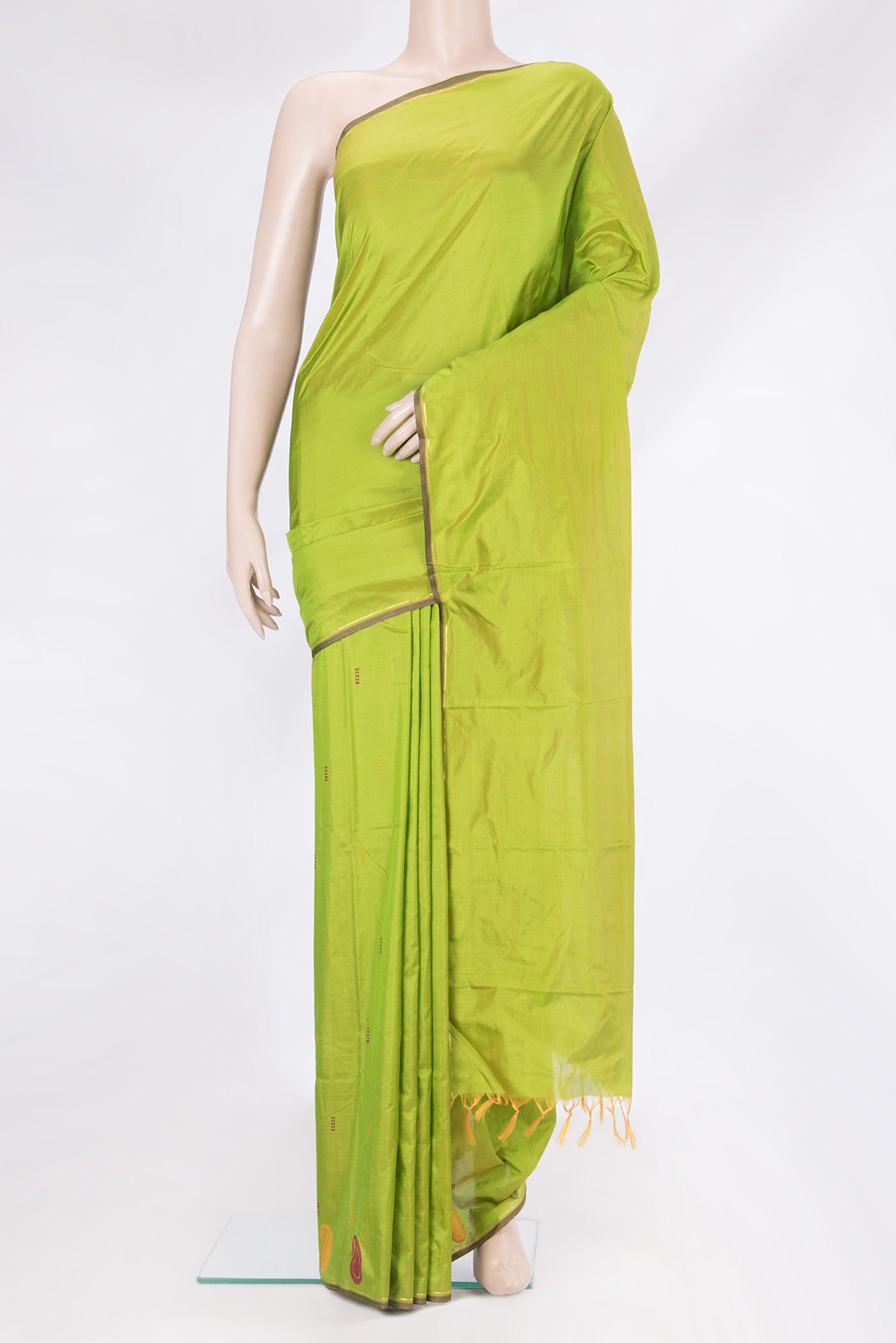 Parrot Green Kanchipuram Silk Saree with Thread Butta on the body and Thread Border.  displayed on a mannequin