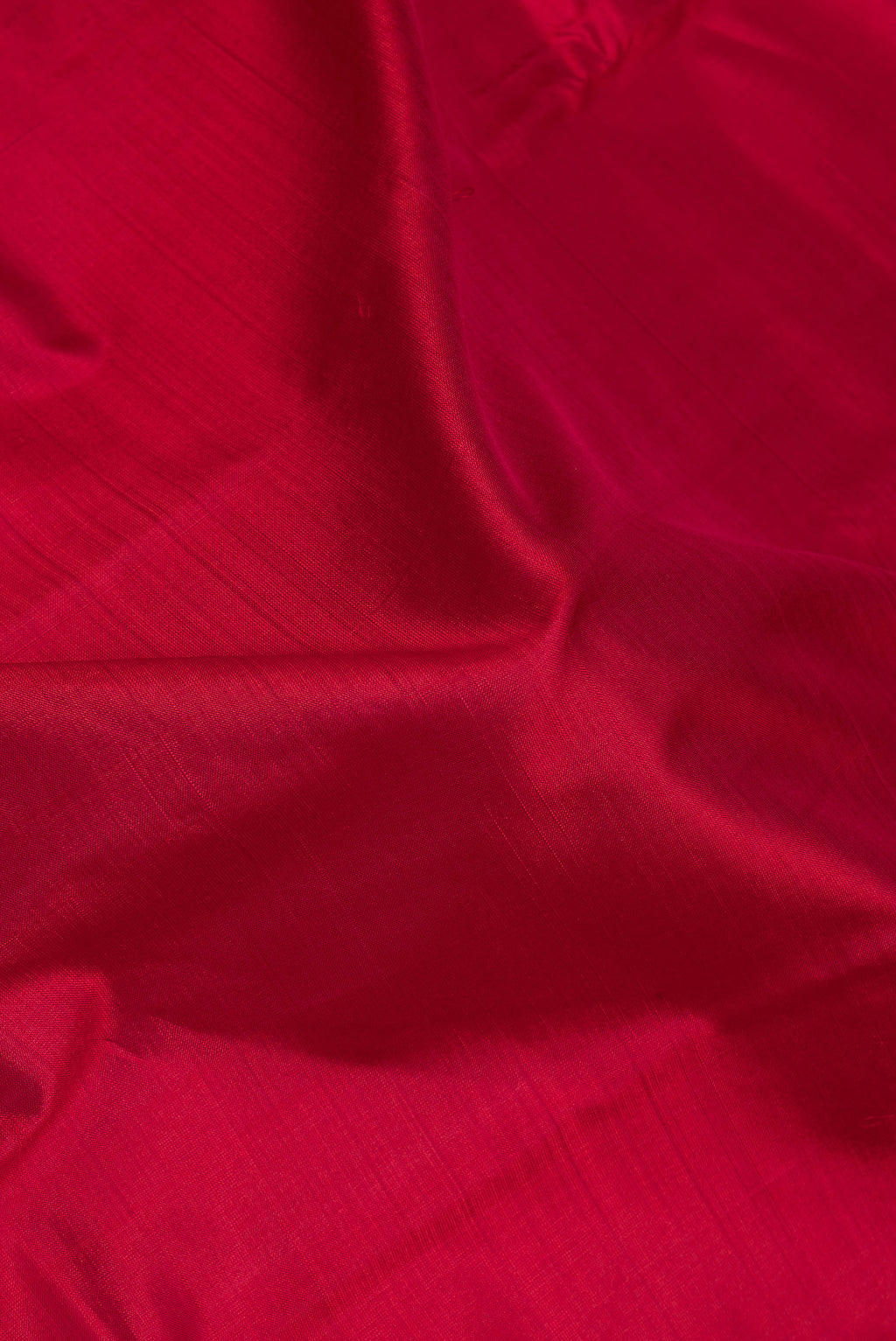 Close up of Maroon Kanchipuram Silk Saree with Plain Body and Zari Border.  displaying folds
