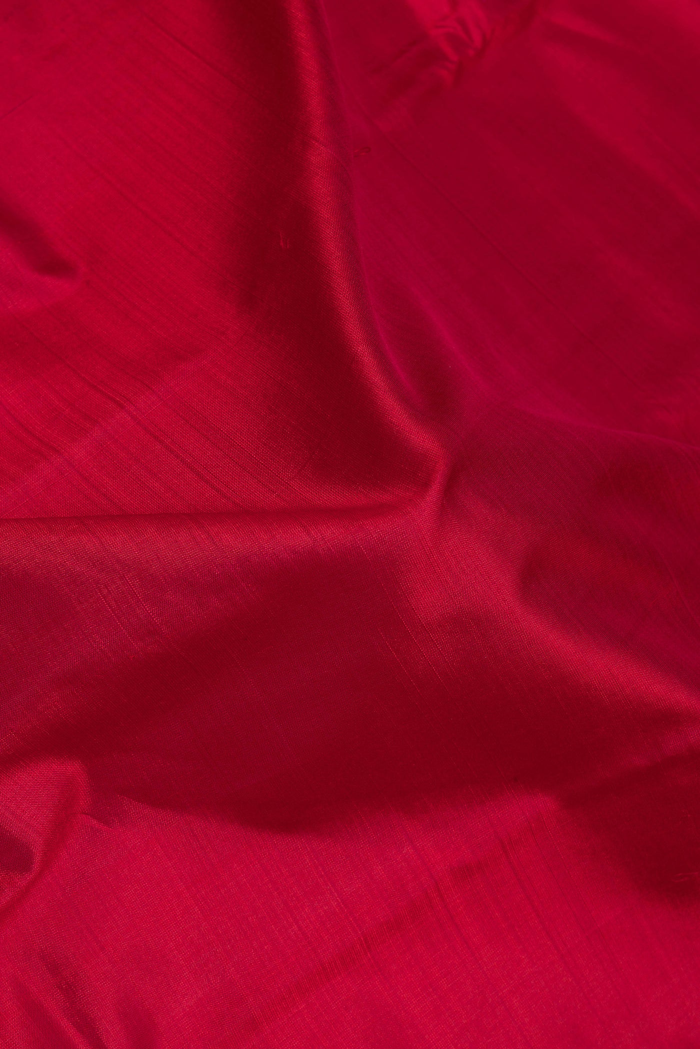 Close up of Maroon Kanchipuram Silk Saree with Plain Body and Zari Border.  displaying folds