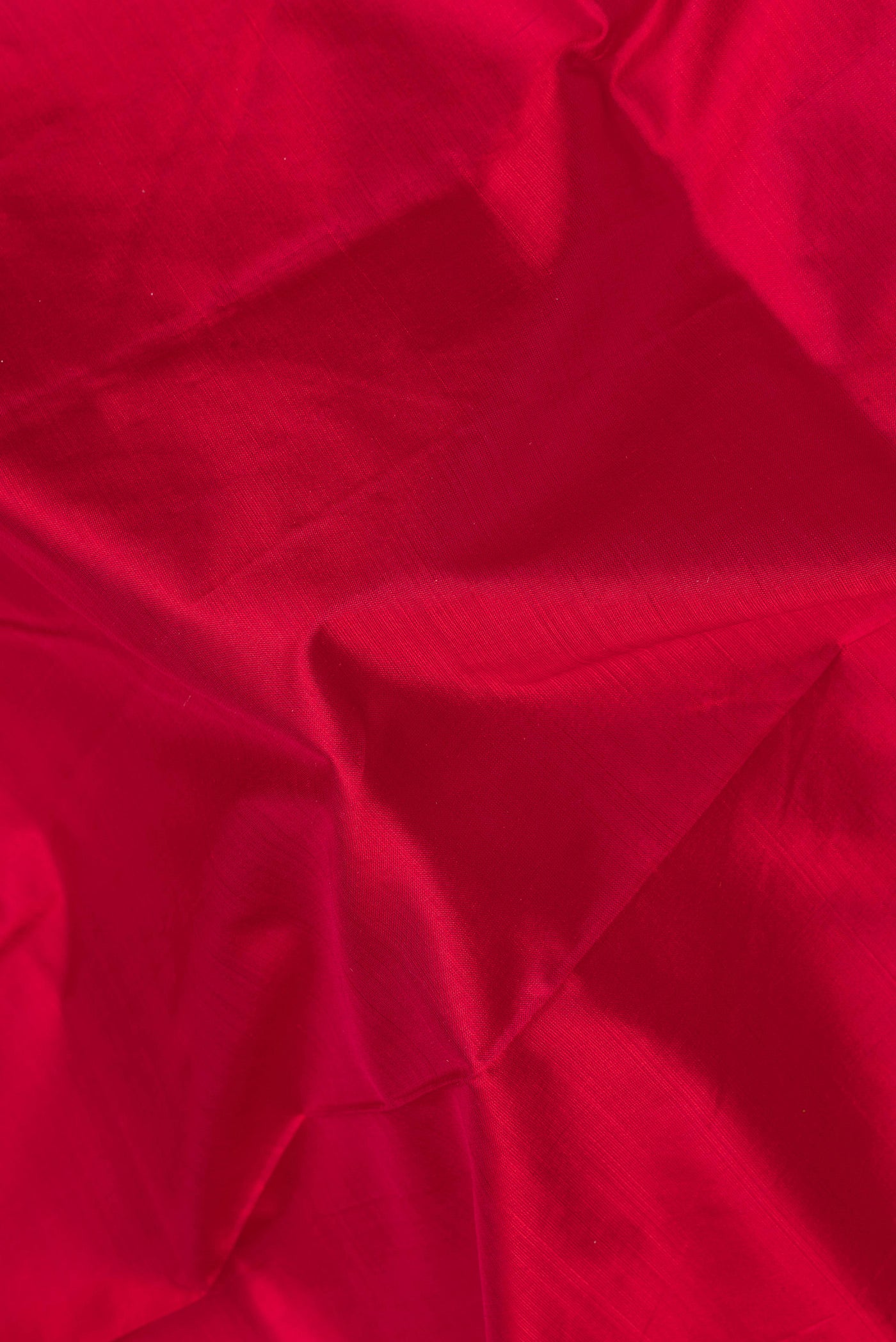 Close up of Maroon Kanchipuram Silk Saree with Plain Body and Zari Border.  displaying folds