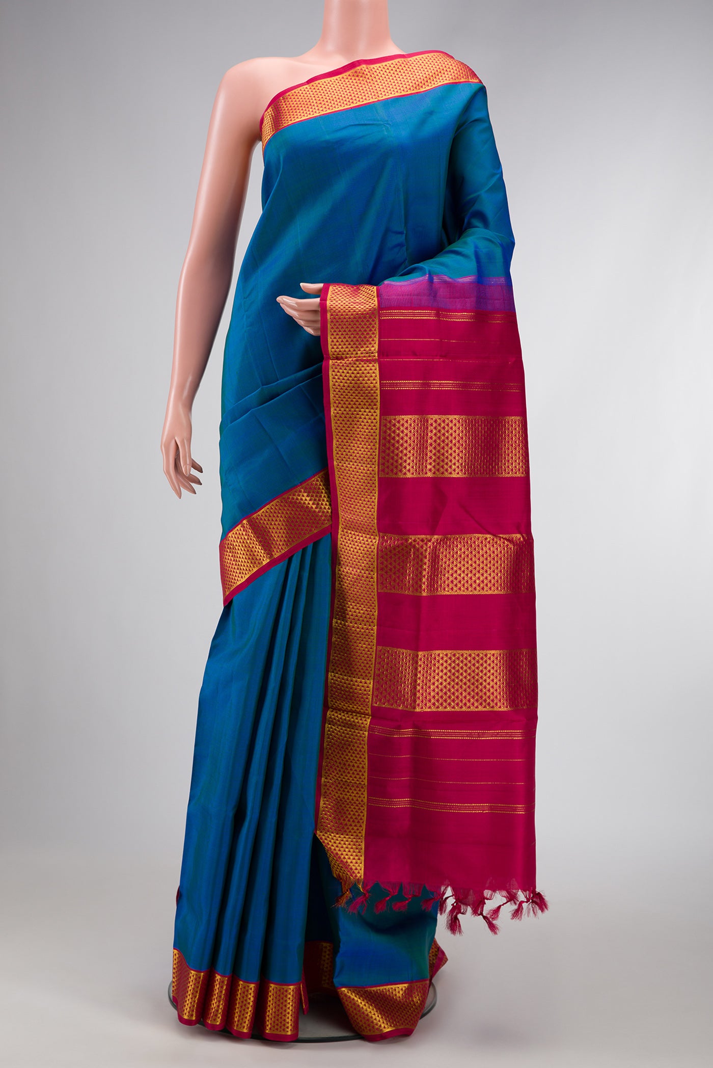 Pure Silk Pure Zari Peacock Blue Dual Tone Kanjivaram Nine Yards Saree with Plain Body and Zari Border.  displayed on a mannequin