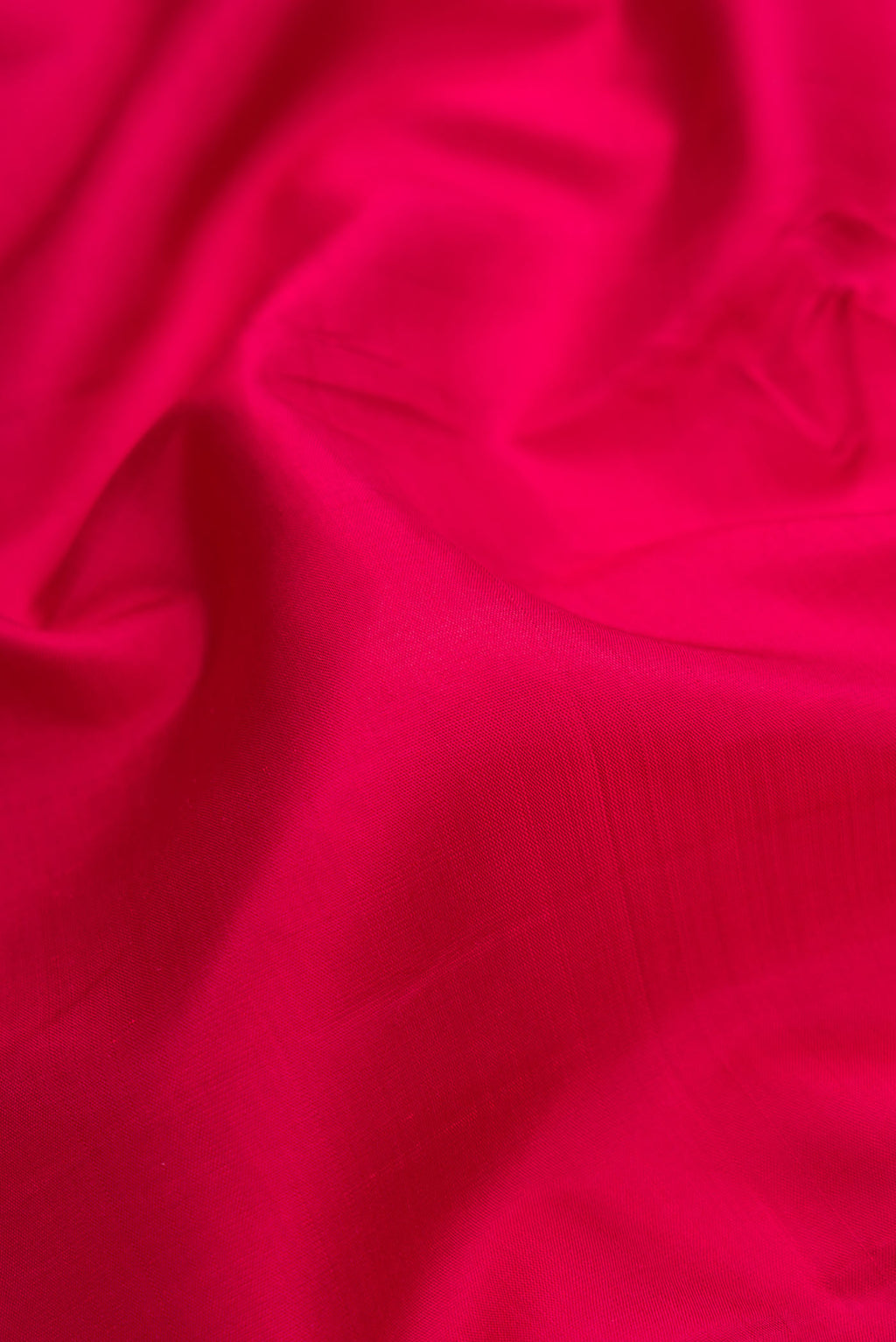 Close up of Maroon Dual Tone Kanjivaram Silk Saree with Plain Body and Zari Border.  displaying folds