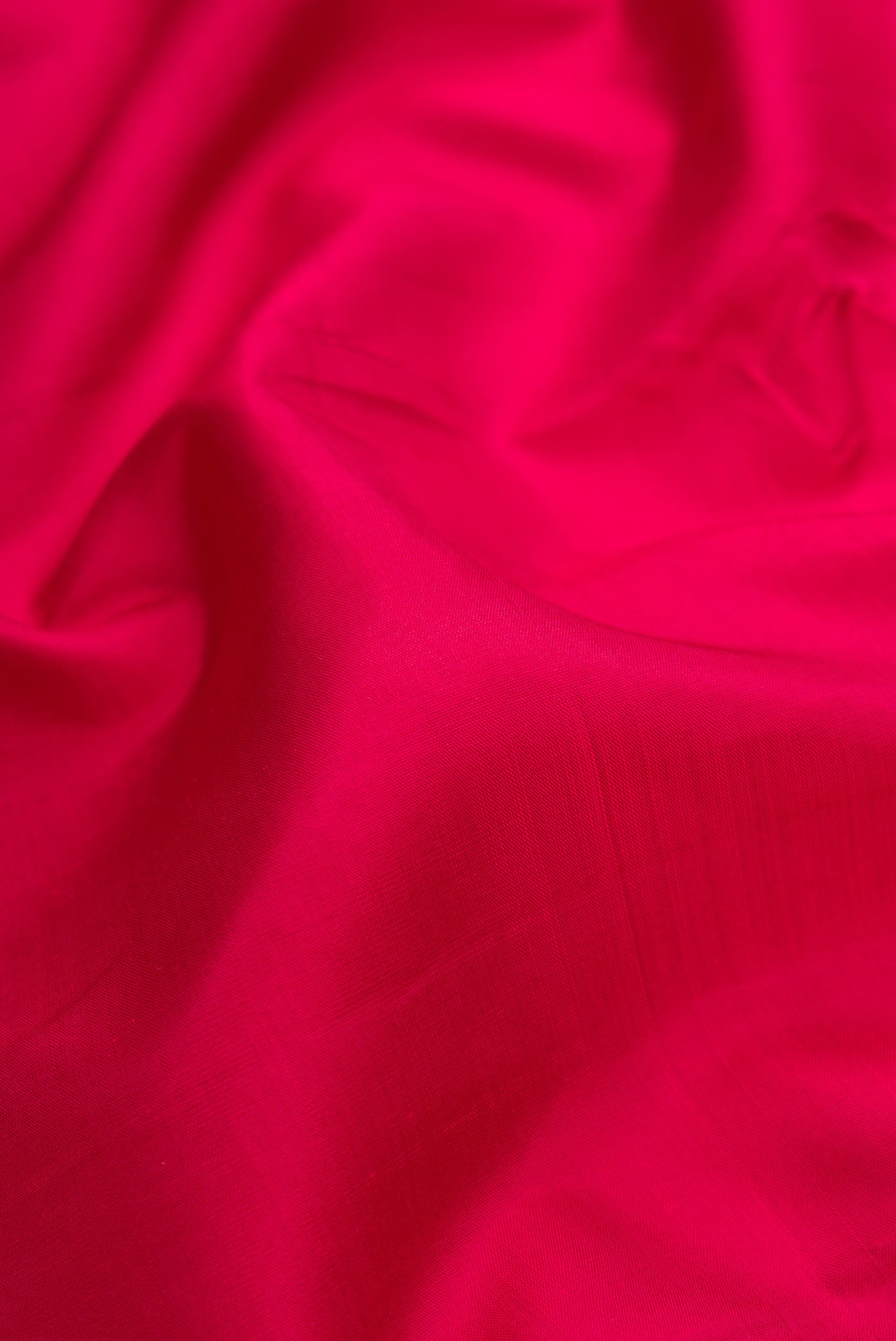 Close up of Maroon Dual Tone Kanjivaram Silk Saree with Plain Body and Zari Border.  displaying folds