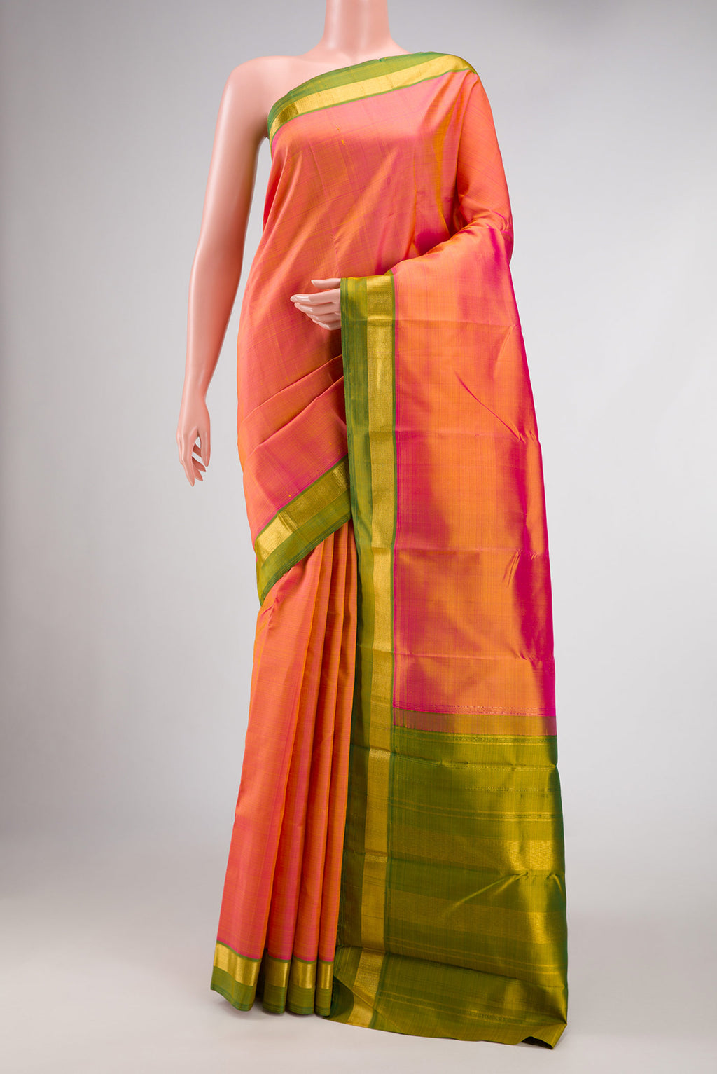 Coral Dual Tone Kanjivaram Silk Saree with Plain Body and Zari Border.  displayed on a mannequin