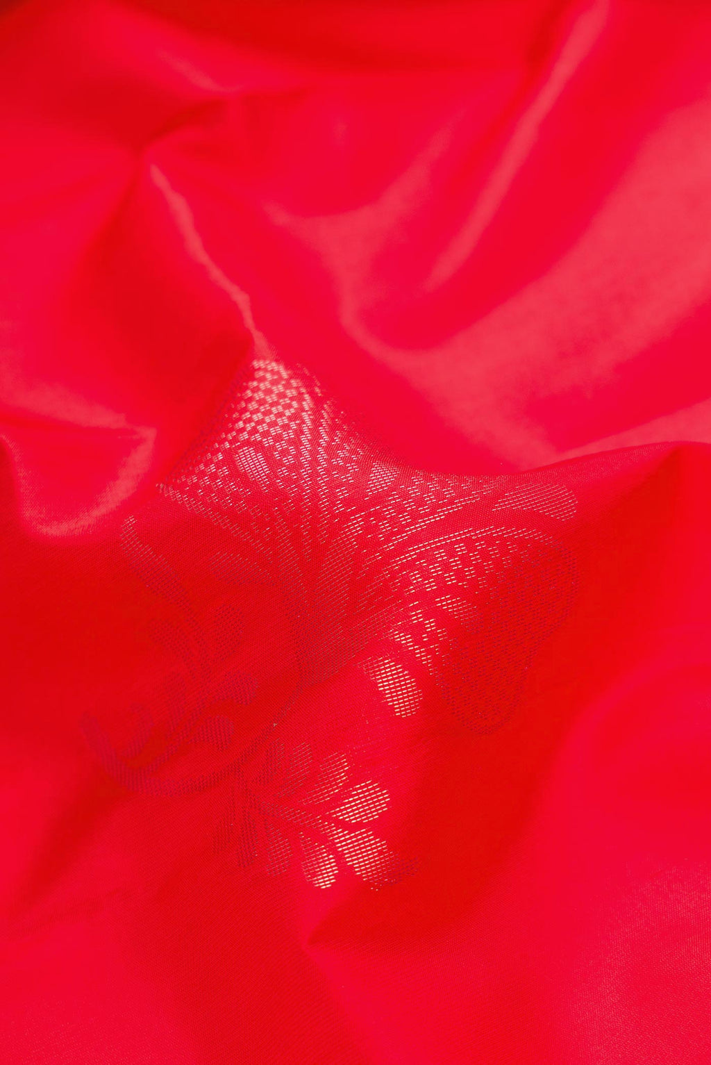 Close up of Red Dual Tone Soft Silk Saree with Zari Butta on the body and Plain Border.  displaying folds