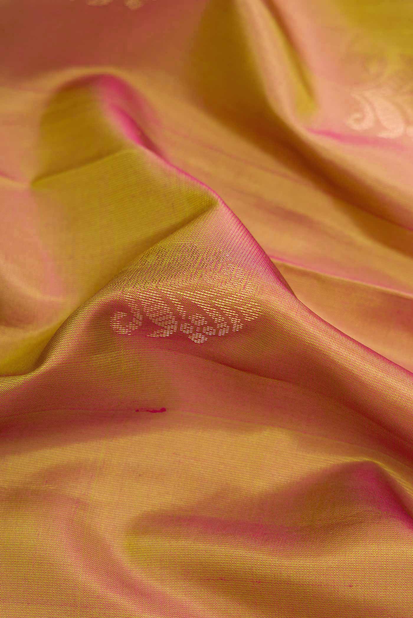 Close up of Mehandi Green Dual Tone Soft Silk Saree with Zari Butta on the body and Fancy Border.  displaying folds