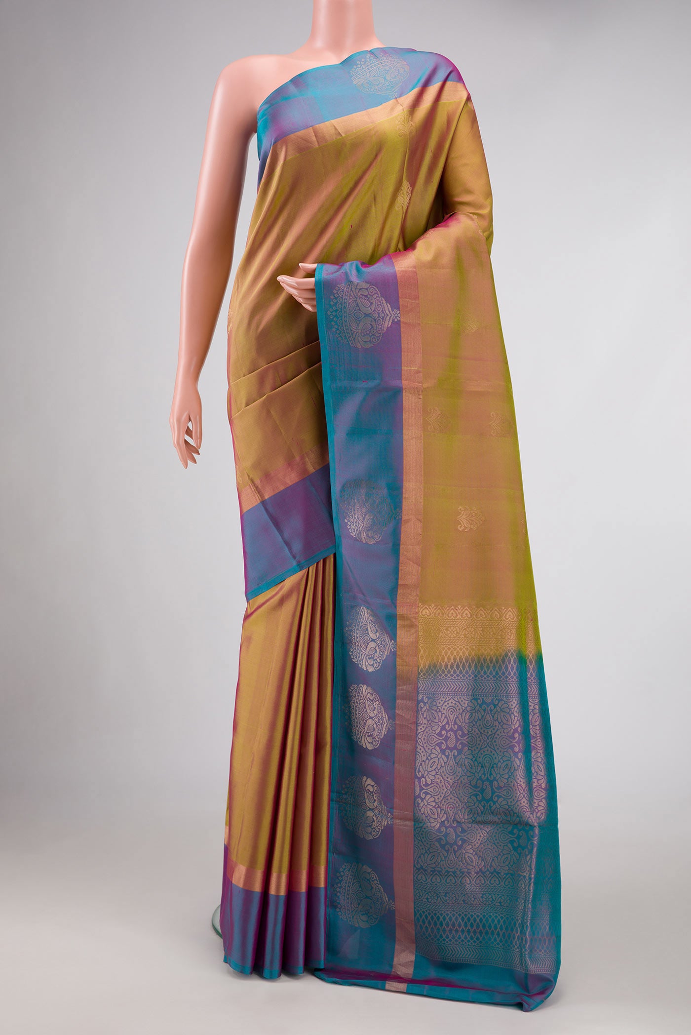 Mehandi Green Dual Tone Soft Silk Saree with Zari Butta on the body and Fancy Border.  displayed on a mannequin