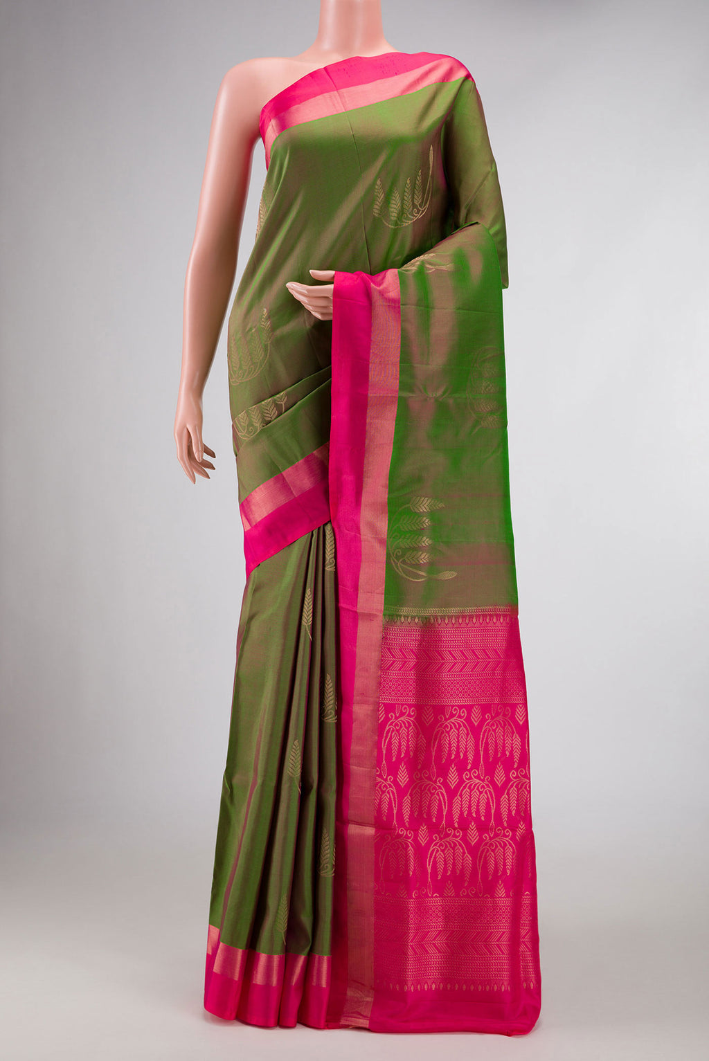 Green Dual Tone Soft Silk Saree with Zari Butta on the body and Zari Border displayed on a mannequin