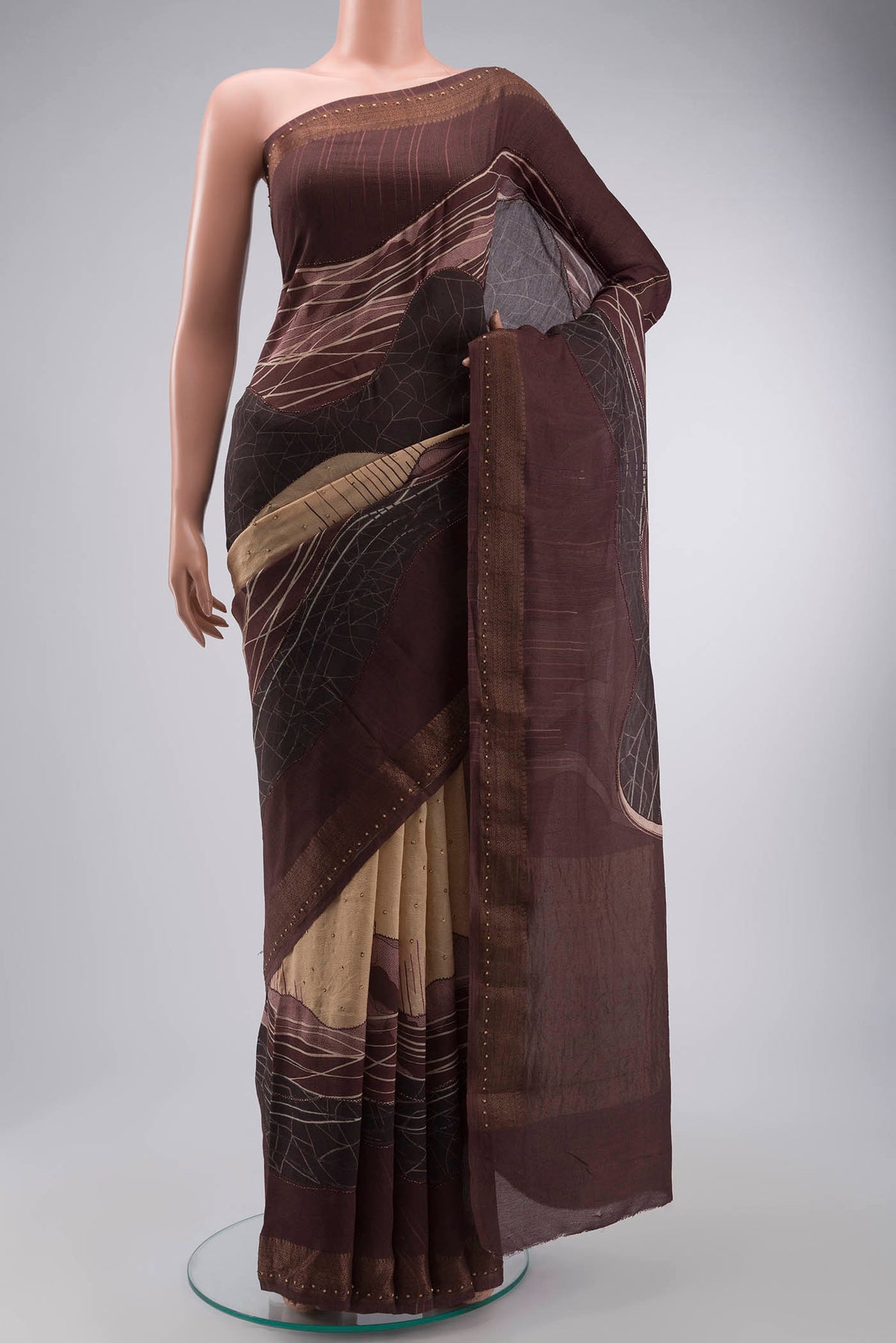 Beige Tussar Silk Saree with Embroidery on the body and Zari Border displayed on a mannequin