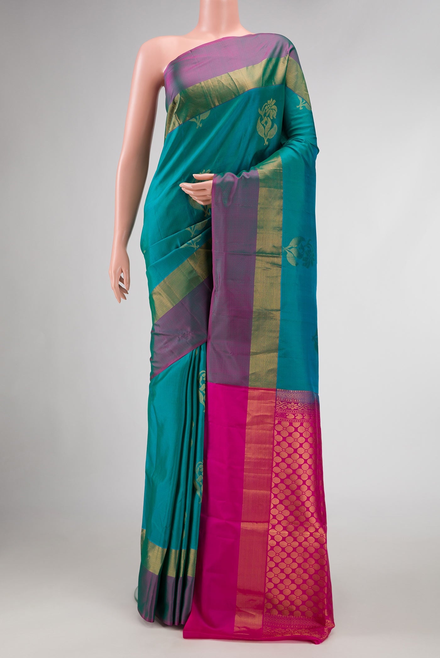 Peacock Blue Dual Tone Soft Silk Saree with Zari Butta on the body and Zari Border.  displayed on a mannequin