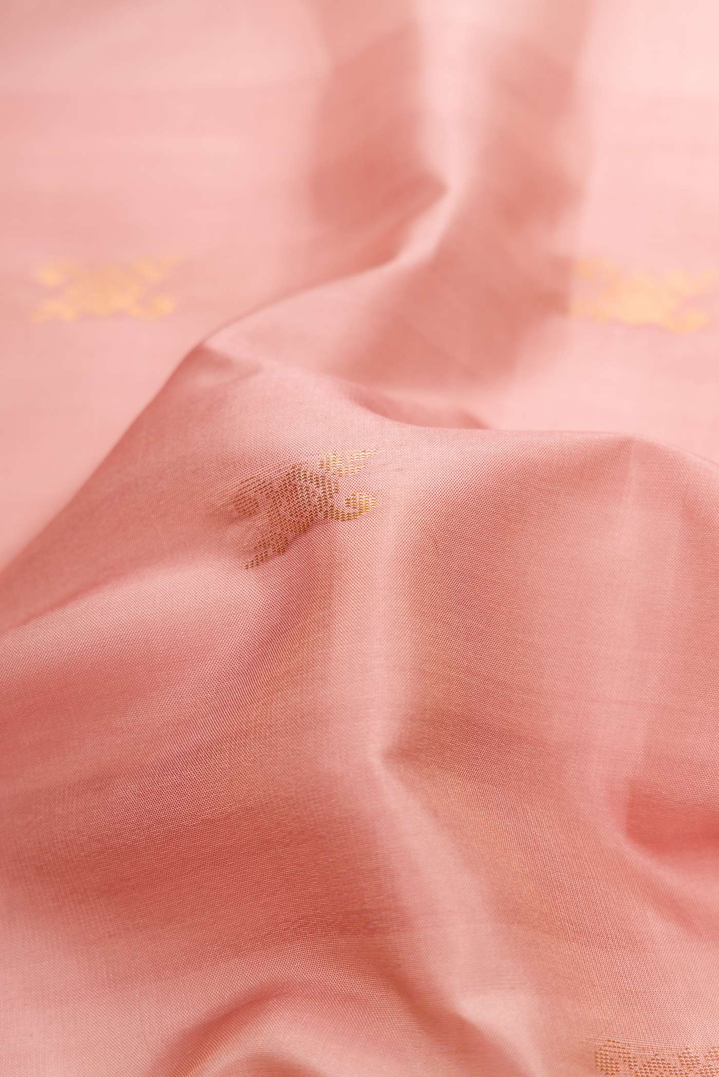 Close up of Pink Dual Tone Soft Silk Saree with Zari Butta on the body and Zari Border.  displaying folds