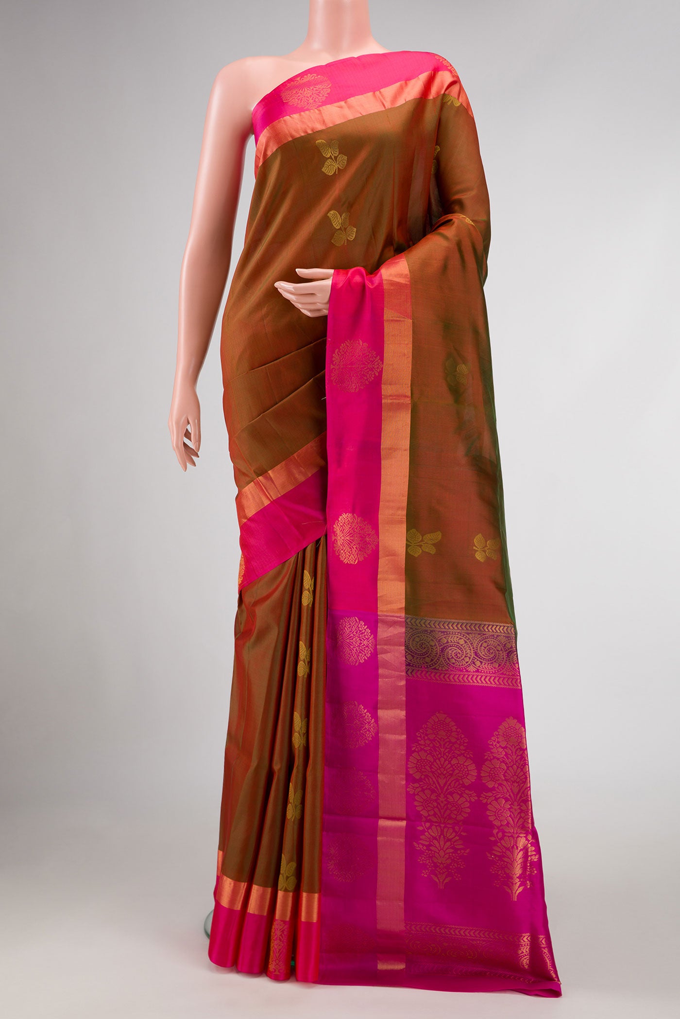 Mehandi Green Dual Tone Soft Silk Saree with Zari Butta on the body and Zari Border.  displayed on a mannequin