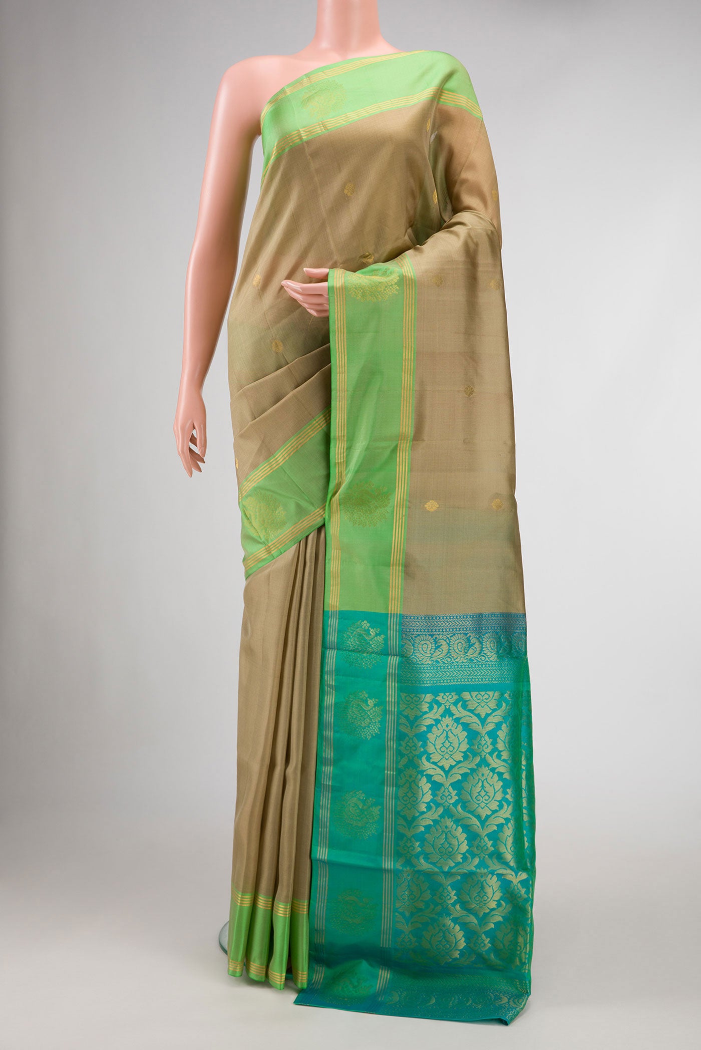 Beige Dual Tone Soft Silk Saree with Zari Butta on the body and Zari Border.  displayed on a mannequin