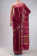 Magenta Banarasi Raw Silk Saree with Zari Butta on the body and Zari Border displayed on a mannequin