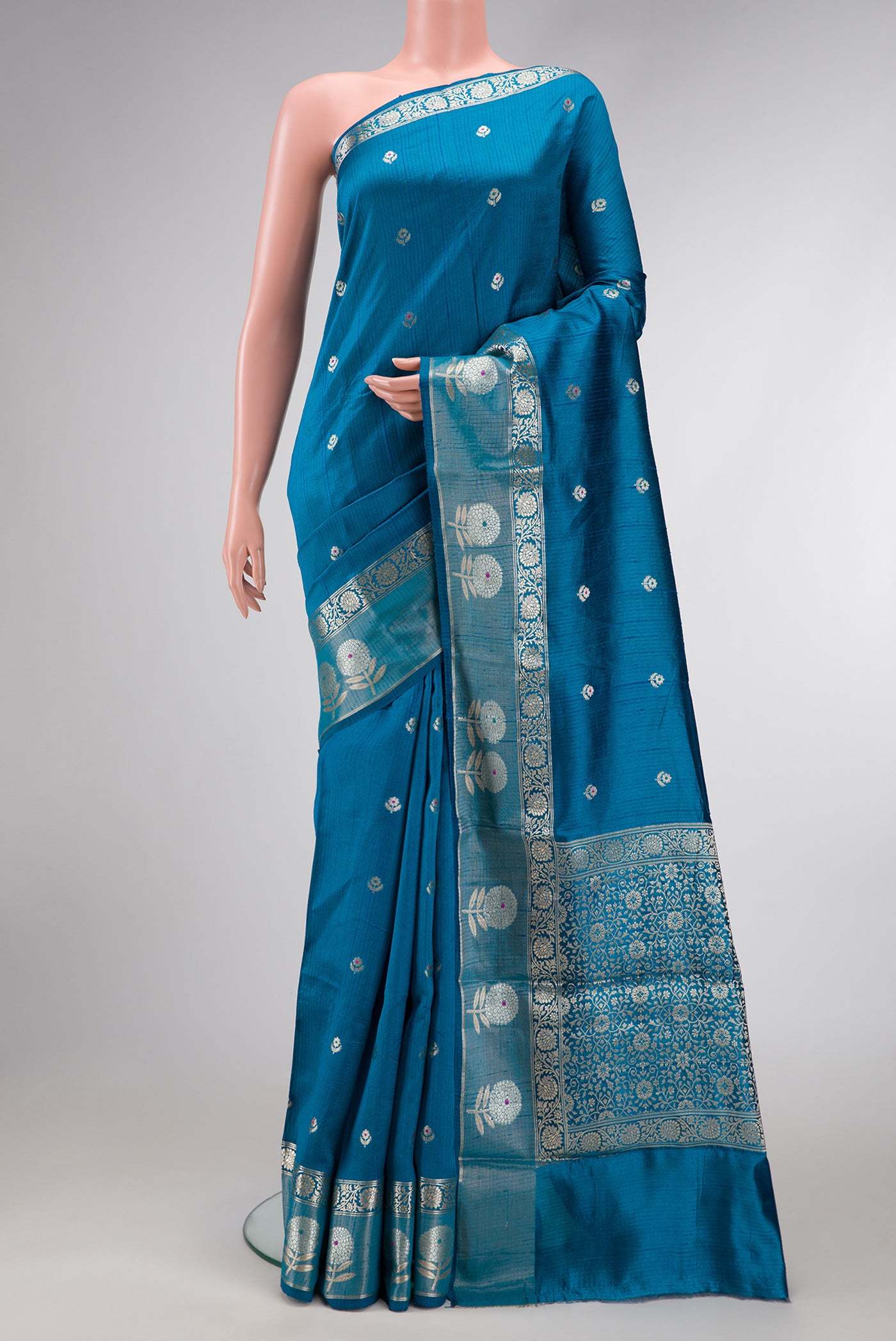 Peacock Blue Dual Tone Tussar Silk Saree with Zari Butta on the body and Zari Border.  displayed on a mannequin
