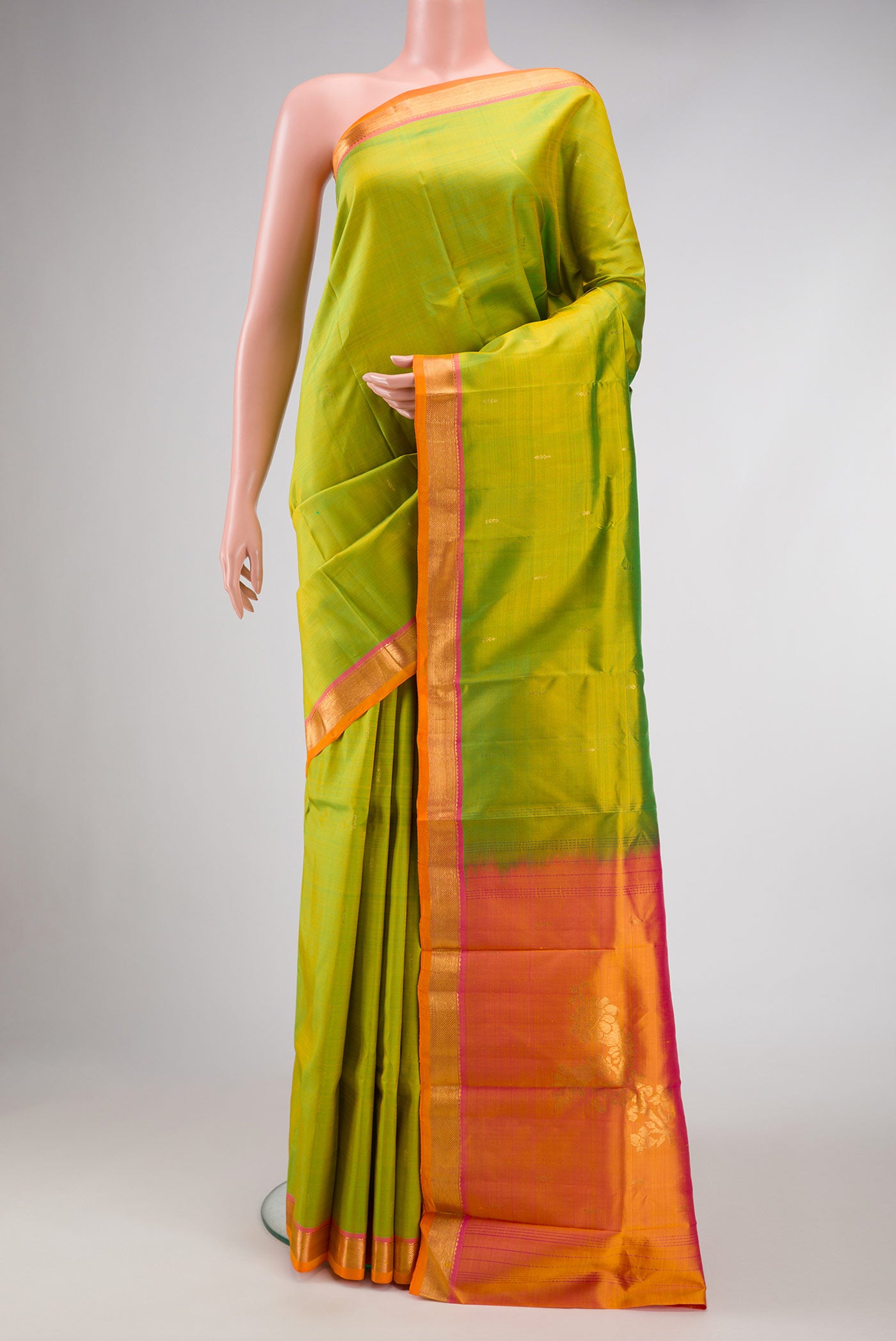 Parrot Green Dual Tone Kanchipuram Silk Saree with Zari Butta on the body and Zari Border.  displayed on a mannequin
