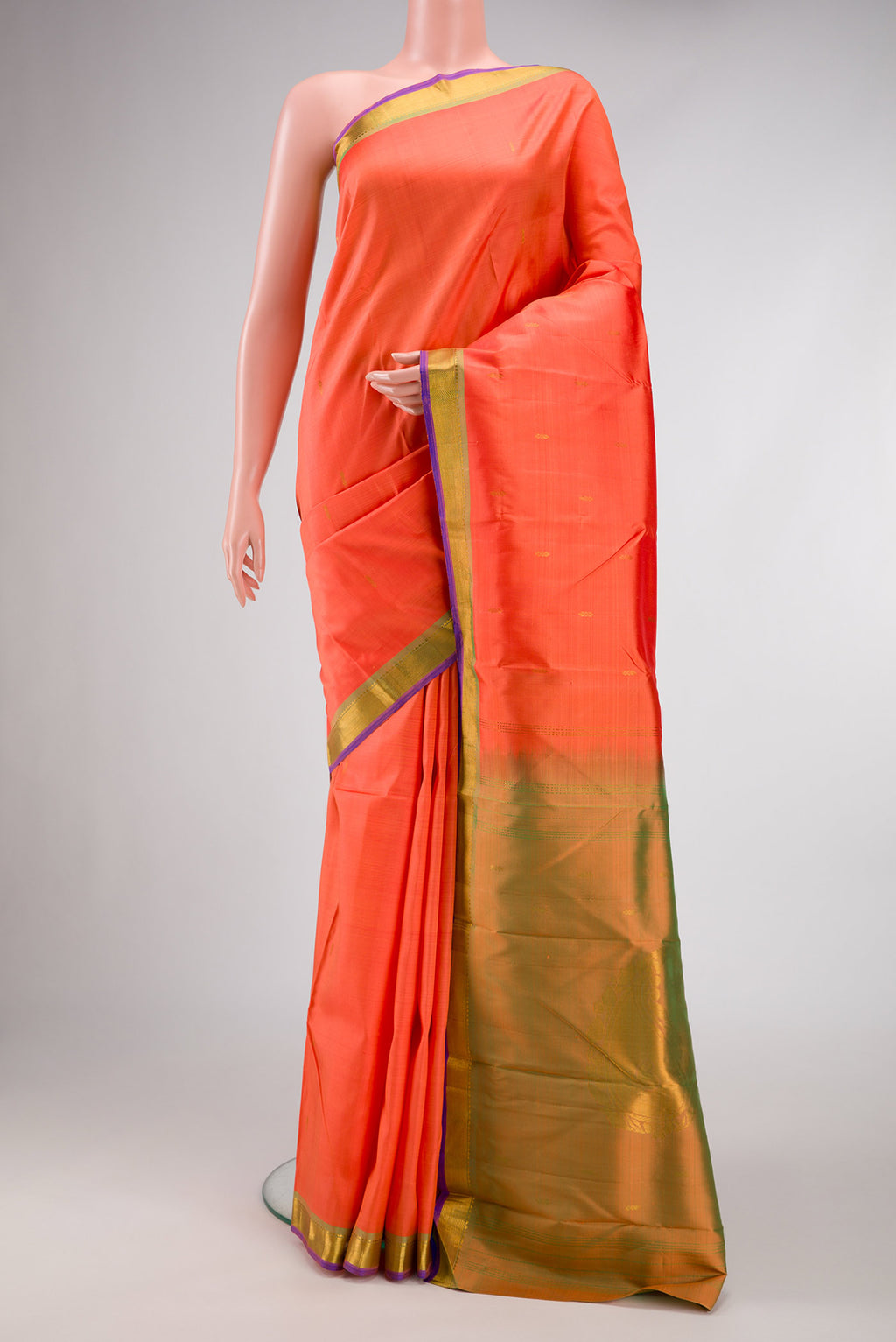 Peach Dual Tone Kanchipuram Silk Saree with Zari Butta on the body and Zari Border.  displayed on a mannequin