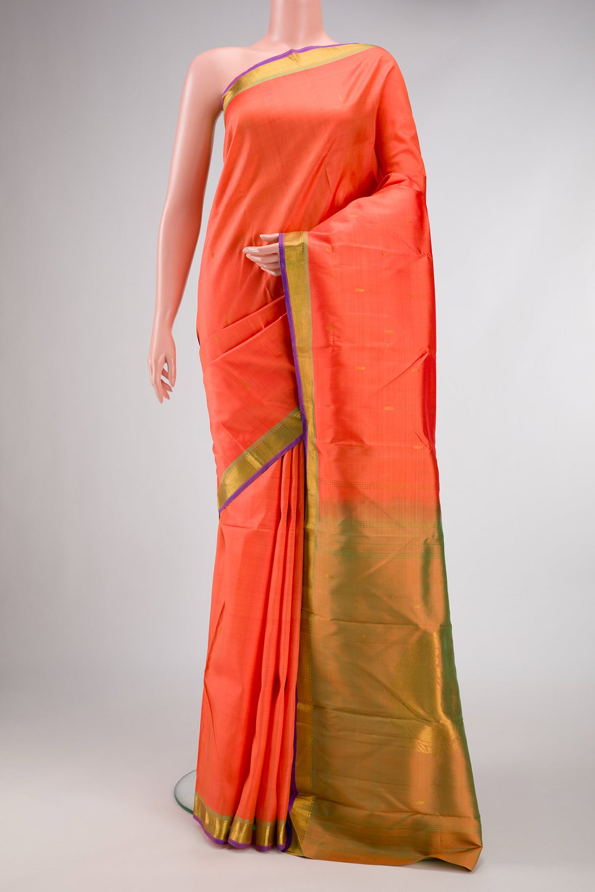 Peach Dual Tone Kanchipuram Silk Saree with Zari Butta on the body and Zari Border.  displayed on a mannequin