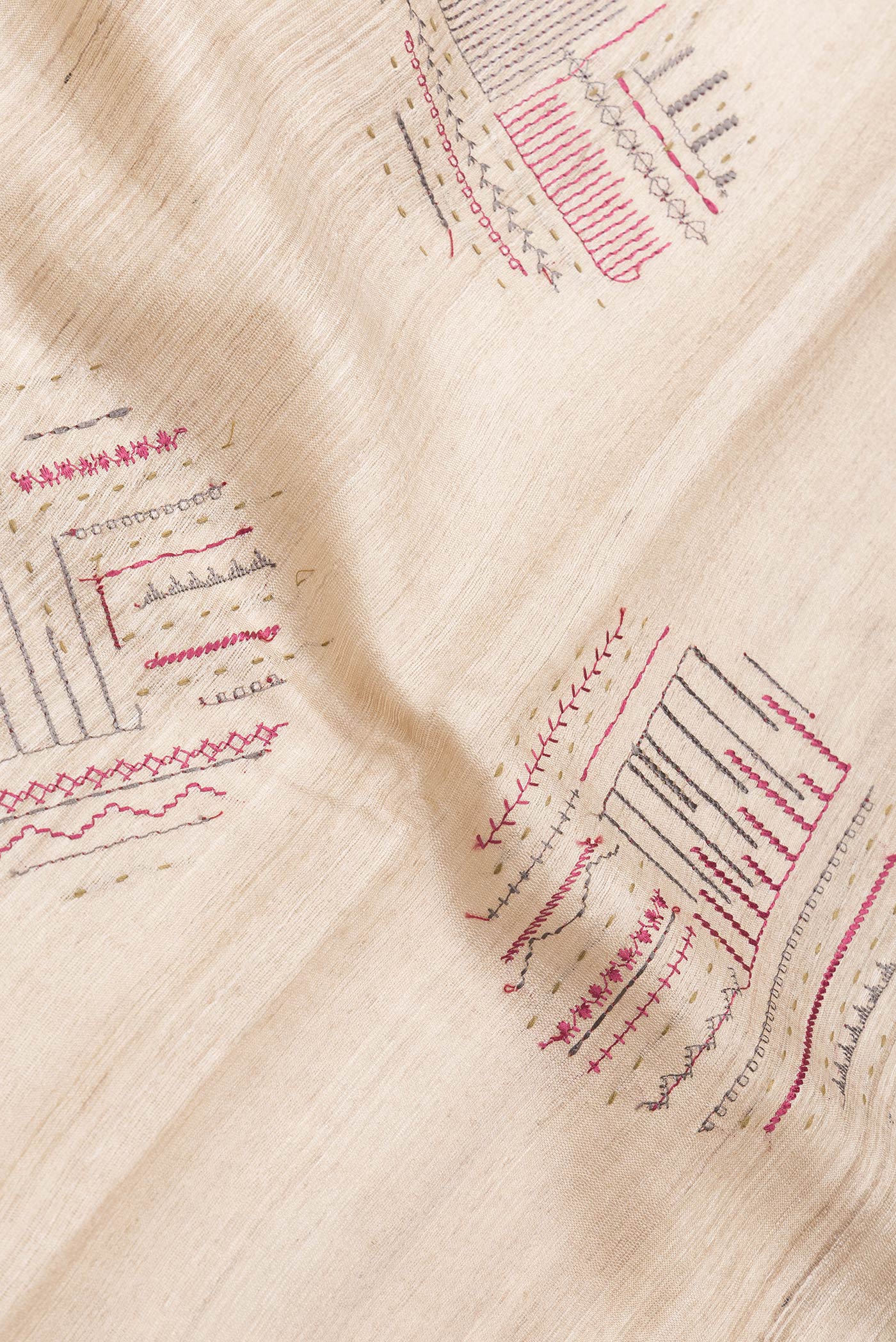 Close up of Beige Dual Tone Tussar Silk Saree with Thread Butta on the body and Zari Border.  displaying folds