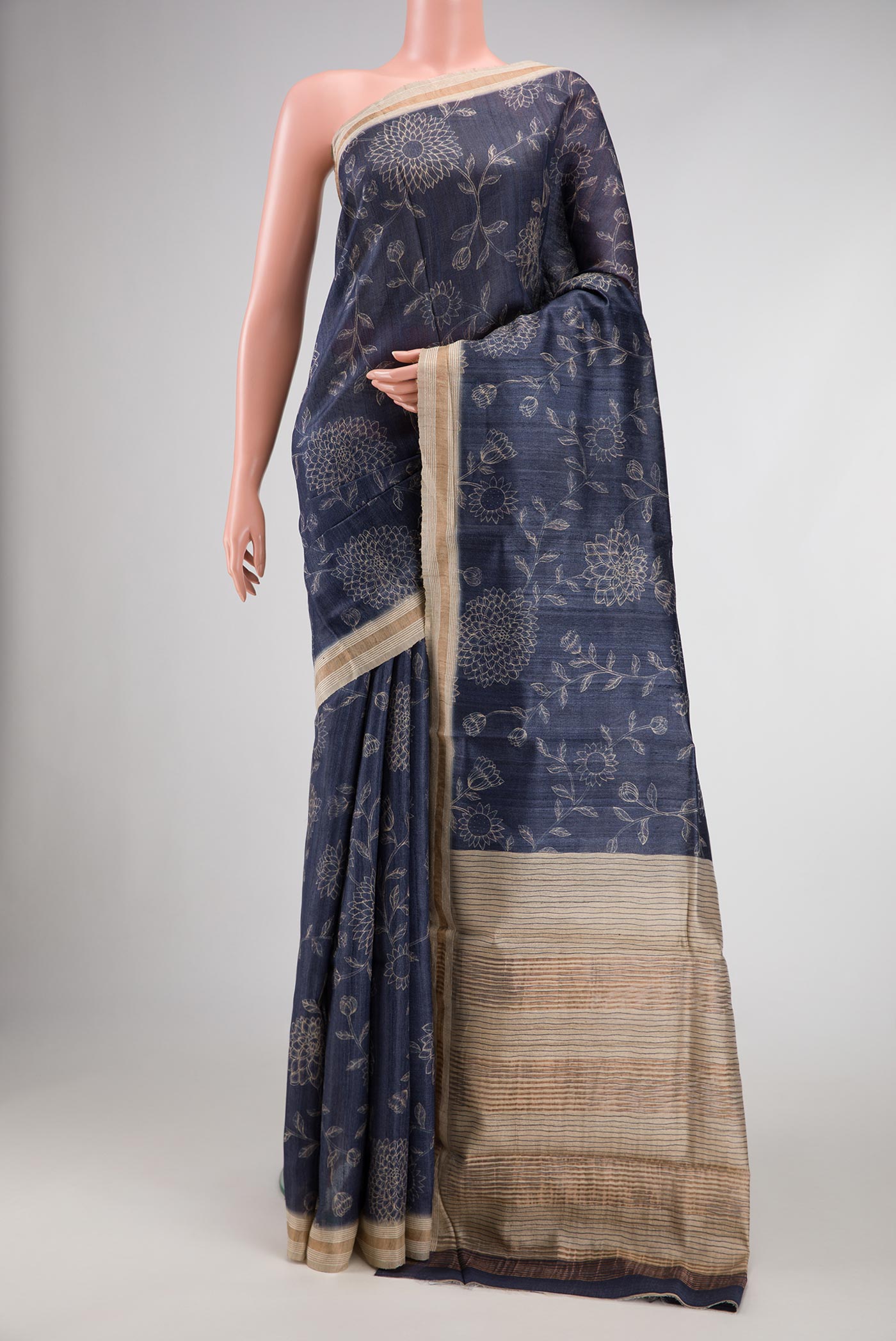Navy Blue Dual Tone Tussar Silk Saree with Printed design on the body and Zari Border.  displayed on a mannequin