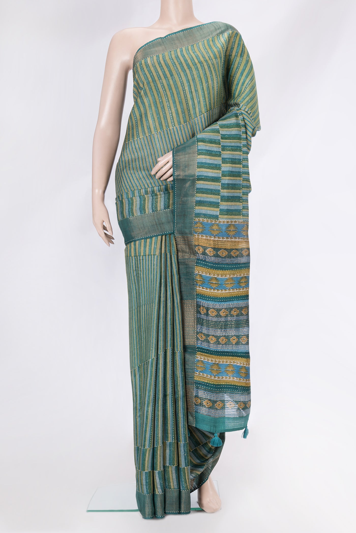 Mehandi Green Tussar Silk Saree with Embroidery on the body and Zari Border.  displayed on a mannequin