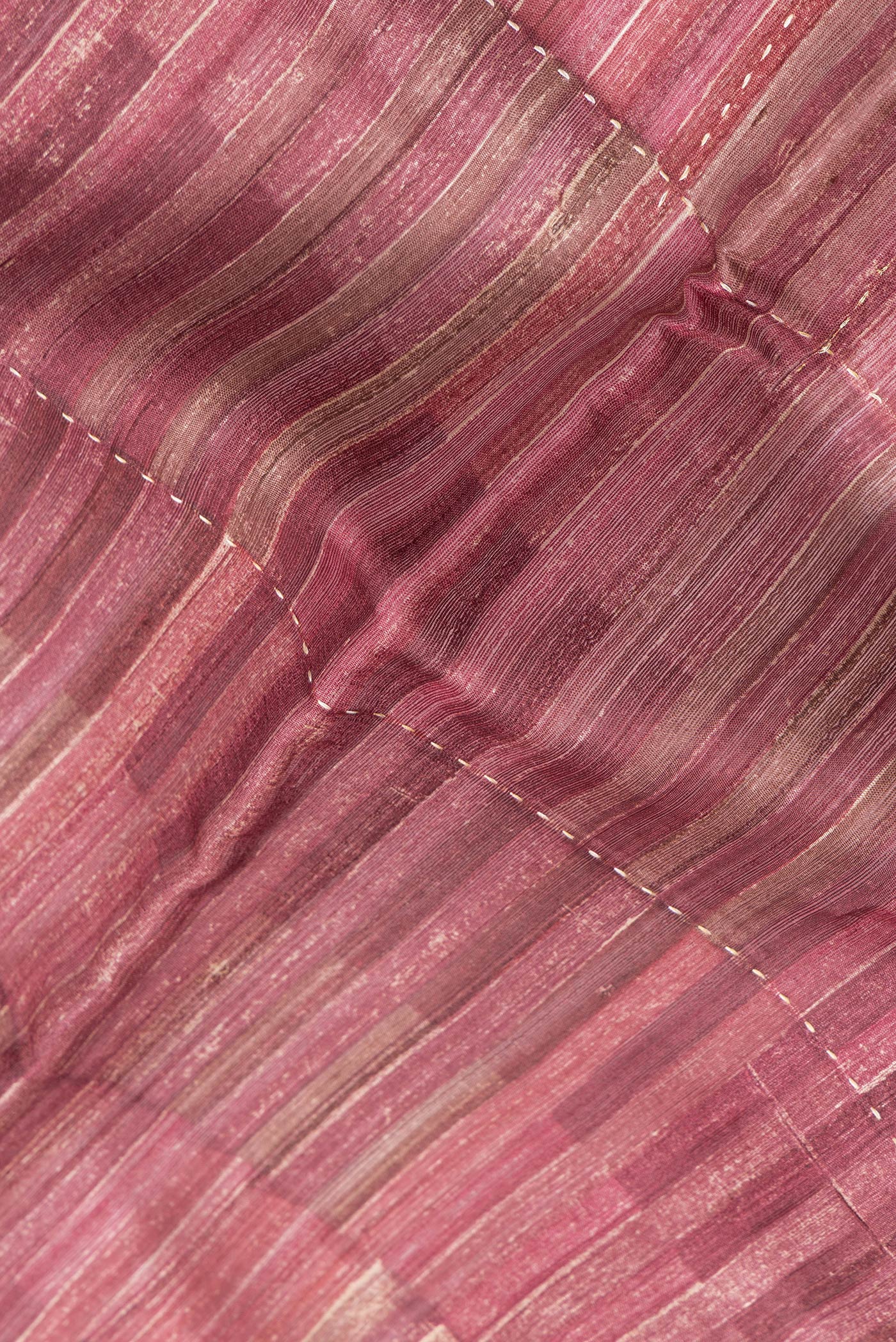 Close up of Magenta Dual Tone Tussar Silk Saree with Embroidery on the body and Zari Border.  displaying folds