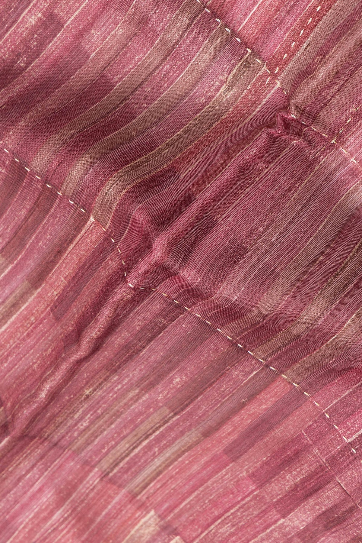 Close up of Magenta Dual Tone Tussar Silk Saree with Embroidery on the body and Zari Border.  displaying folds