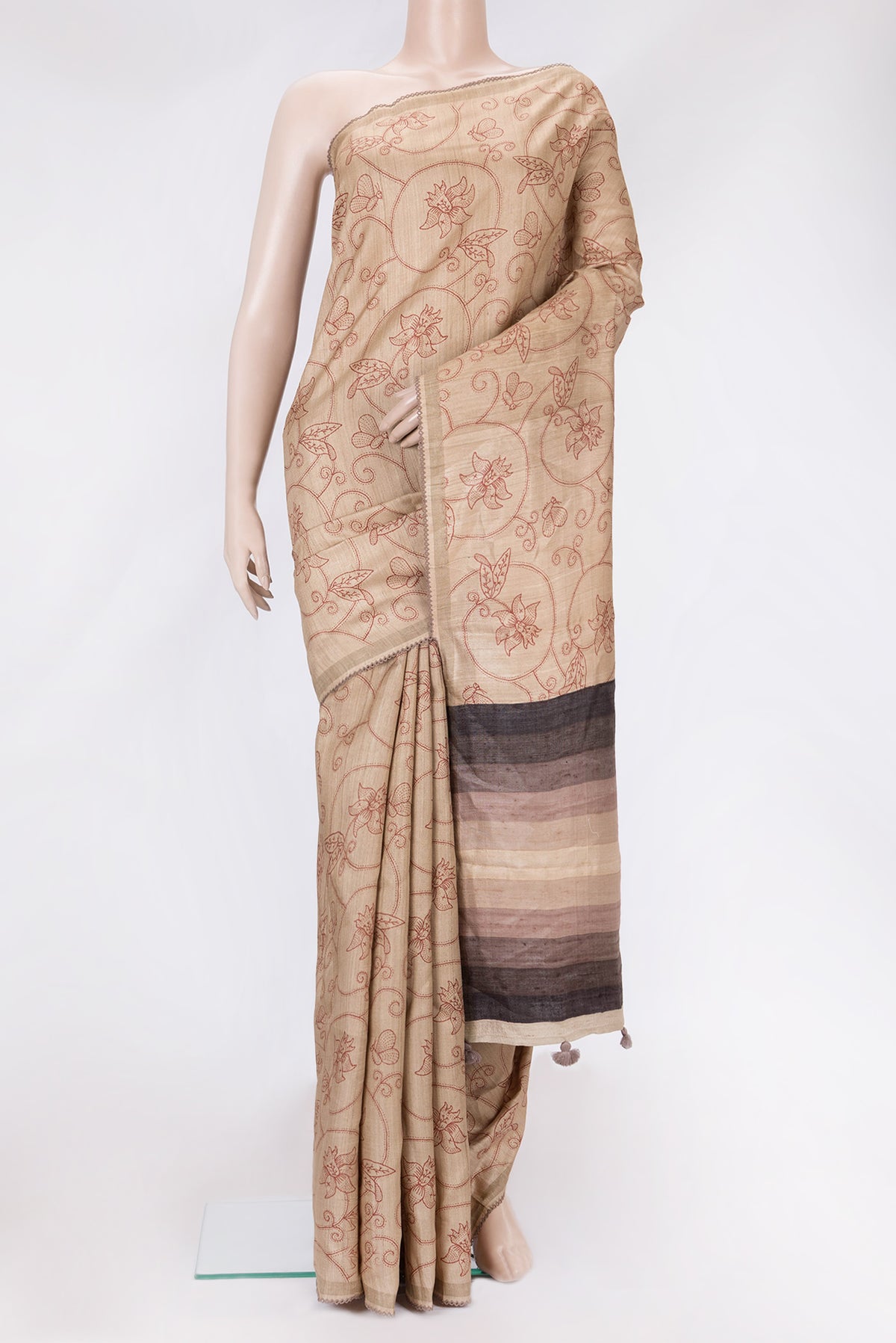 Beige Dual Tone Tussar Silk Saree with Printed design on the body and Embroidery Border.  displayed on a mannequin