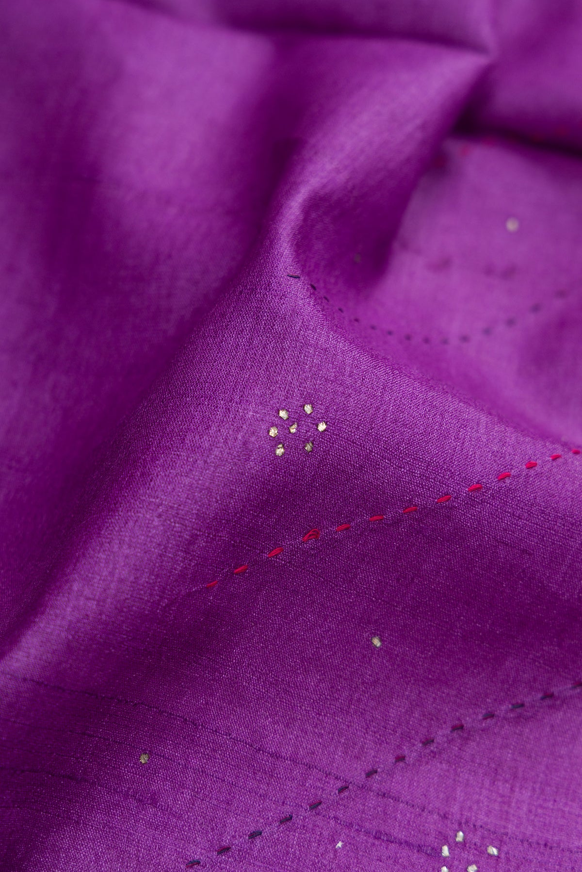 Close up of Purple Dual Tone Tussar Silk Saree with Embroidery on the body and Embroidery Border.  displaying folds
