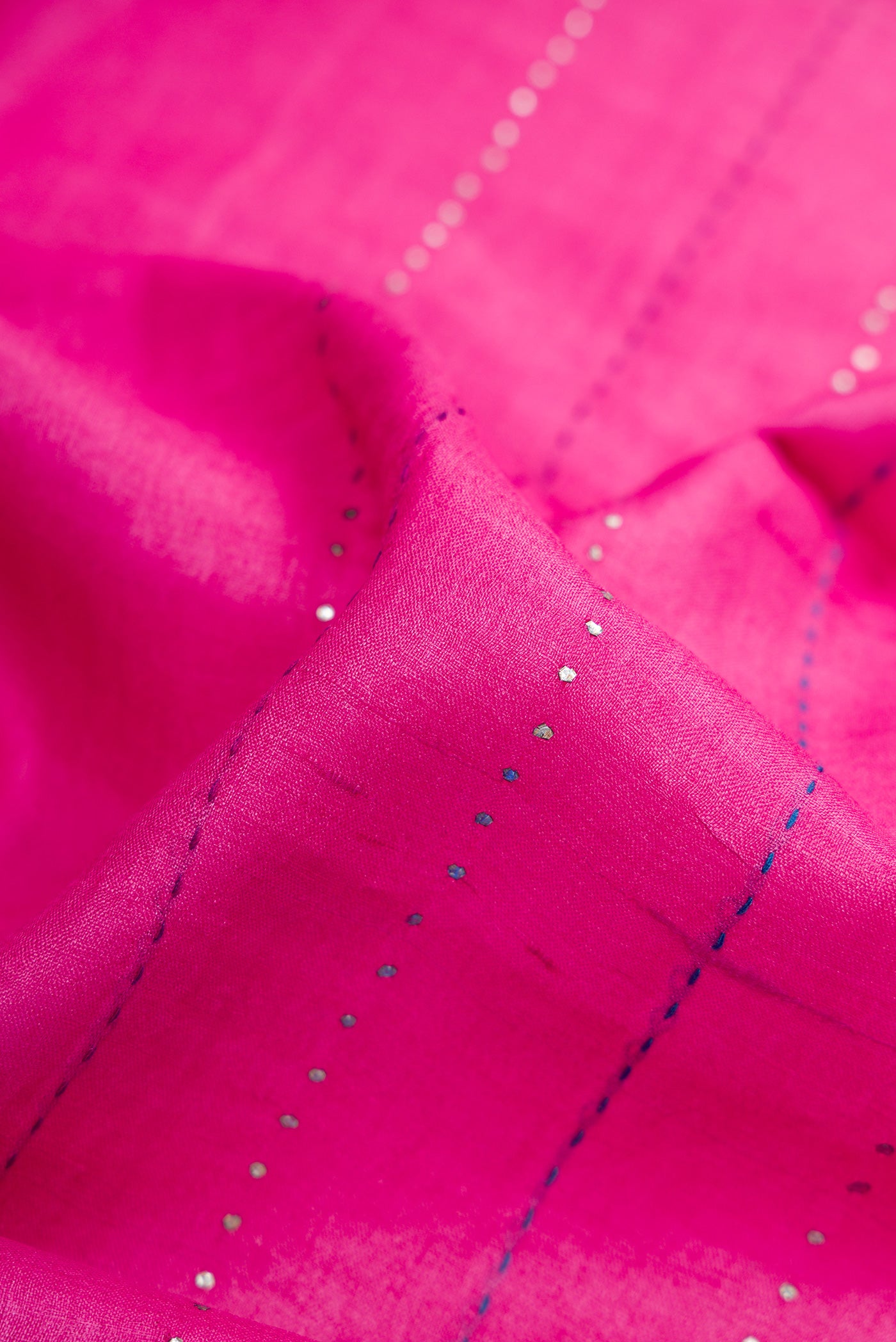 Close up of Pink Dual Tone Tussar Silk Saree with Embroidery on the body and Embroidery Border.  displaying folds