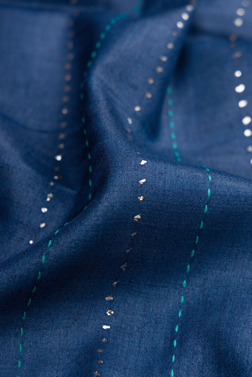 Close up of Navy Blue Dual Tone Tussar Silk Saree with Embroidery on the body and Embroidery Border.  displaying folds